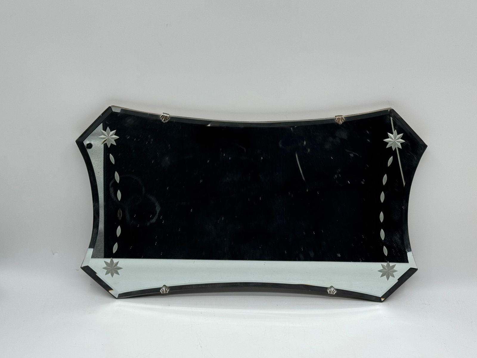 Etched Glass Beveled Wall Mirror, 24 x 14 inches: Vintage etched glass wall mirror. Features beveled edges and starburst etching. Dimensions: 24 inches long, 14 inches high.