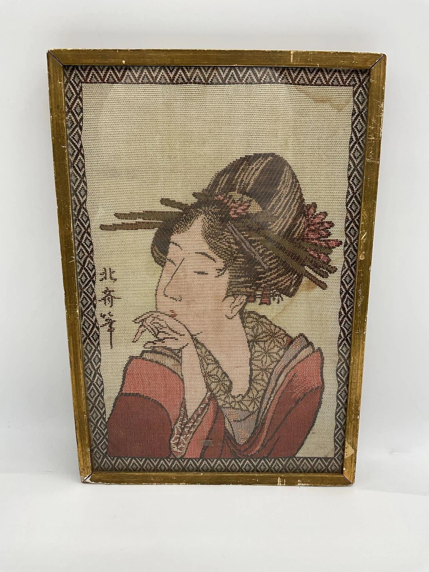Embroidered Portrait After Kitagawa Utamaro: Framed textile embroidery depicting a woman in traditional Japanese dress with elaborate hair ornaments, modeled after an original woodblock print by Kitagawa Utamaro. Signed in kanji on left. Dimensi
