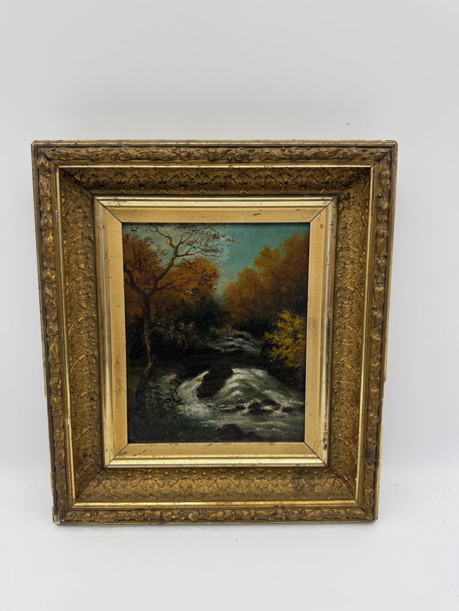 Landscape Painting with Waterfall, Framed: Oil on canvas landscape painting depicting a waterfall scene. The painting is housed in a decorative gilt frame. Dimensions: 13 x 15 inches (framed).