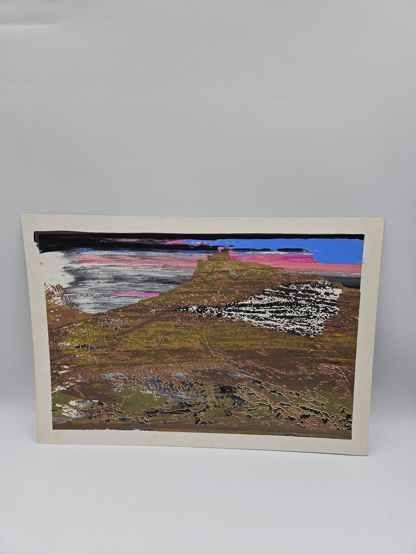 Abstract Landscape Artwork: Contemporary mixed media piece depicting a stylized landscape with textured earthy tones and vibrant color accents in blue, pink, and black. The layered application of paint and abstract horizon line