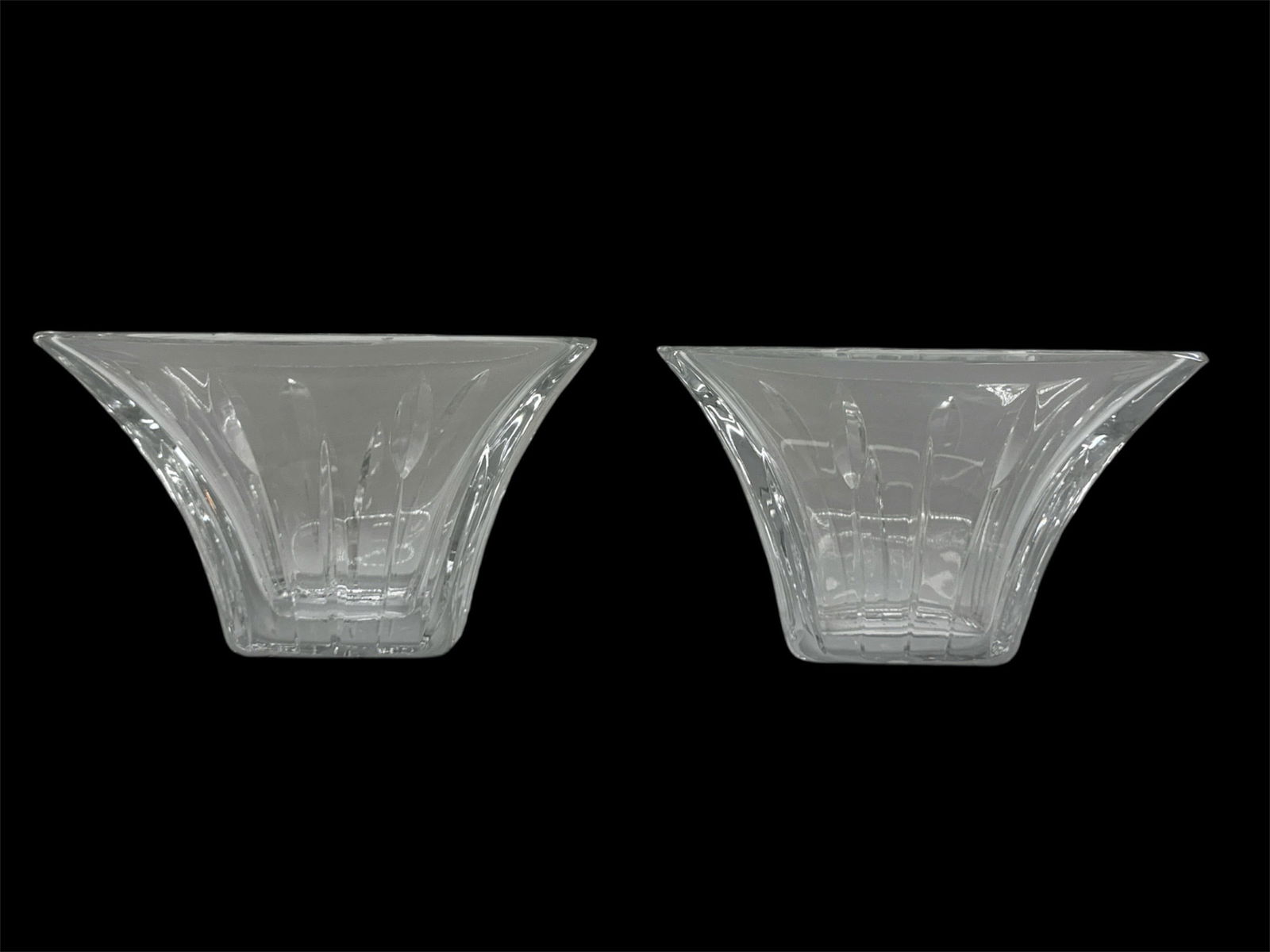 Pair of Clear Art Glass Flared Square Bowls: A pair of clear art glass bowls featuring a flared square form with gently angled sides and a faceted pedestal base. Each bowl displays molded radiating and geometric patterns that enhance light refle