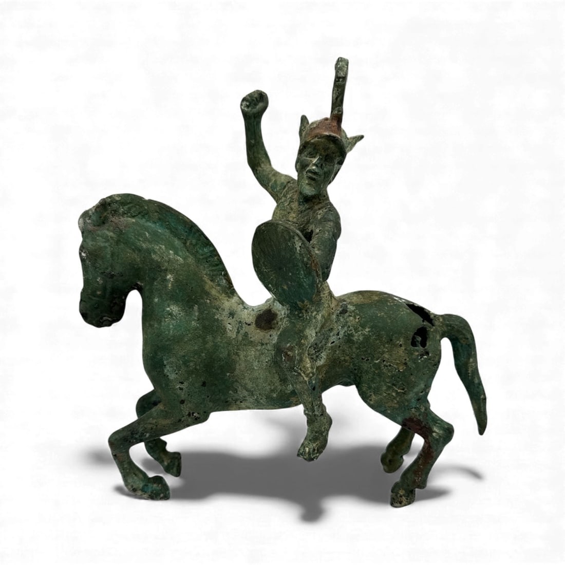 Etruscan Bronze Equestrian Figure from approximately 6th Century: Etruscan Bronze figure depicting a warrior with shield riding a horse. Etruscan refers to the advanced, mysterious civilization that flourished in ancient central Italy (Etruria) from