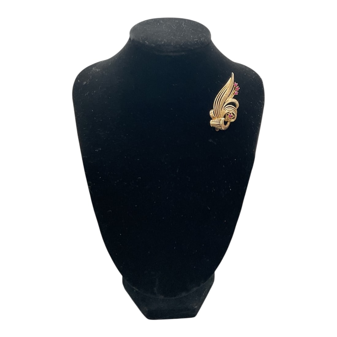 14K Gold Brooch with Ruby Accents: Elegant 14K gold brooch featuring a flowing, sculptural design accented with small rubies. The brooch displays a layered, ribbon like motif with textured gold surfaces and bezel set ruby stones