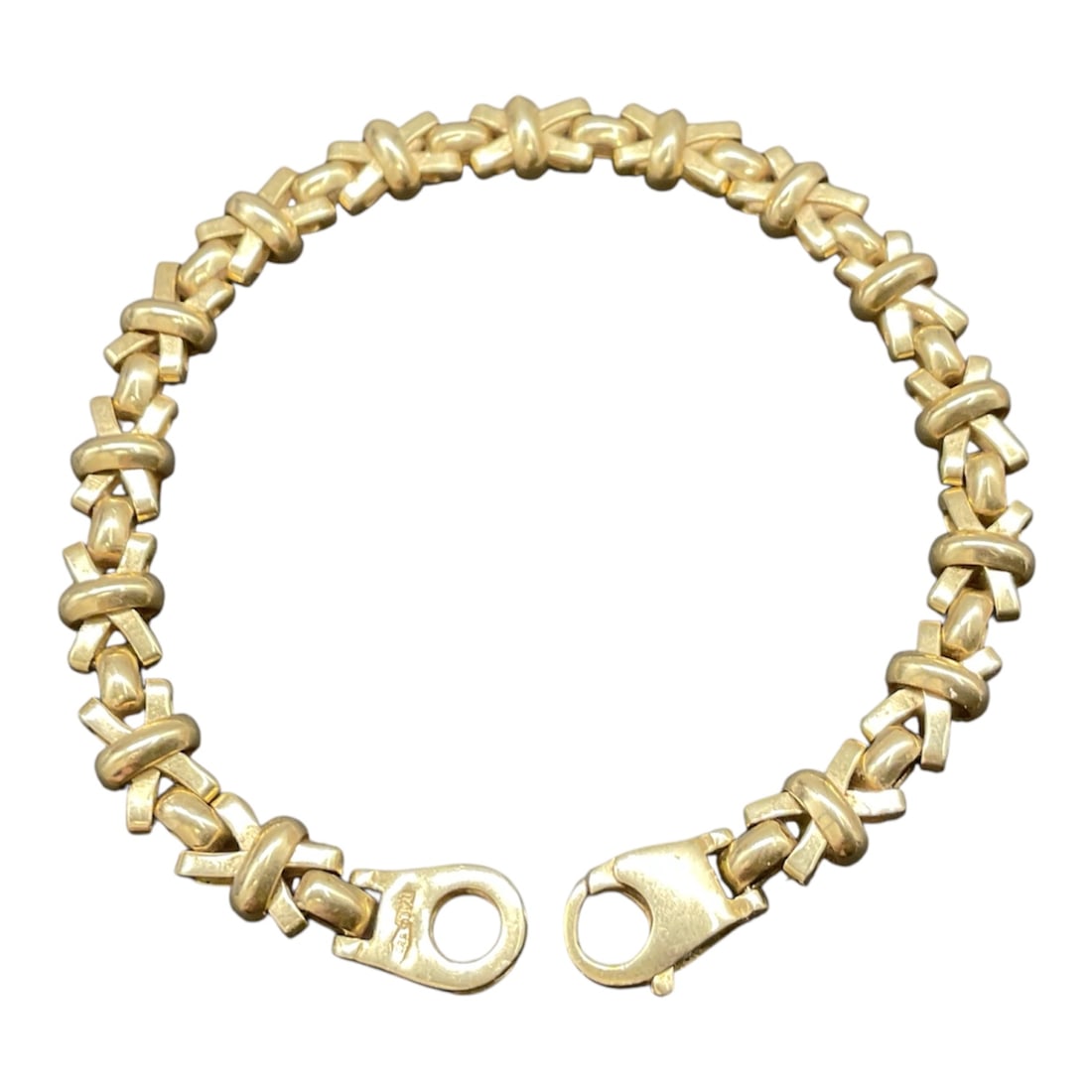 14K Gold XO Link Bracelet: 14K gold XO link bracelet featuring an alternating X and O style link pattern in a polished finish. The bracelet displays dimensional interlocking forms creating a continuous decorative motif. Secured