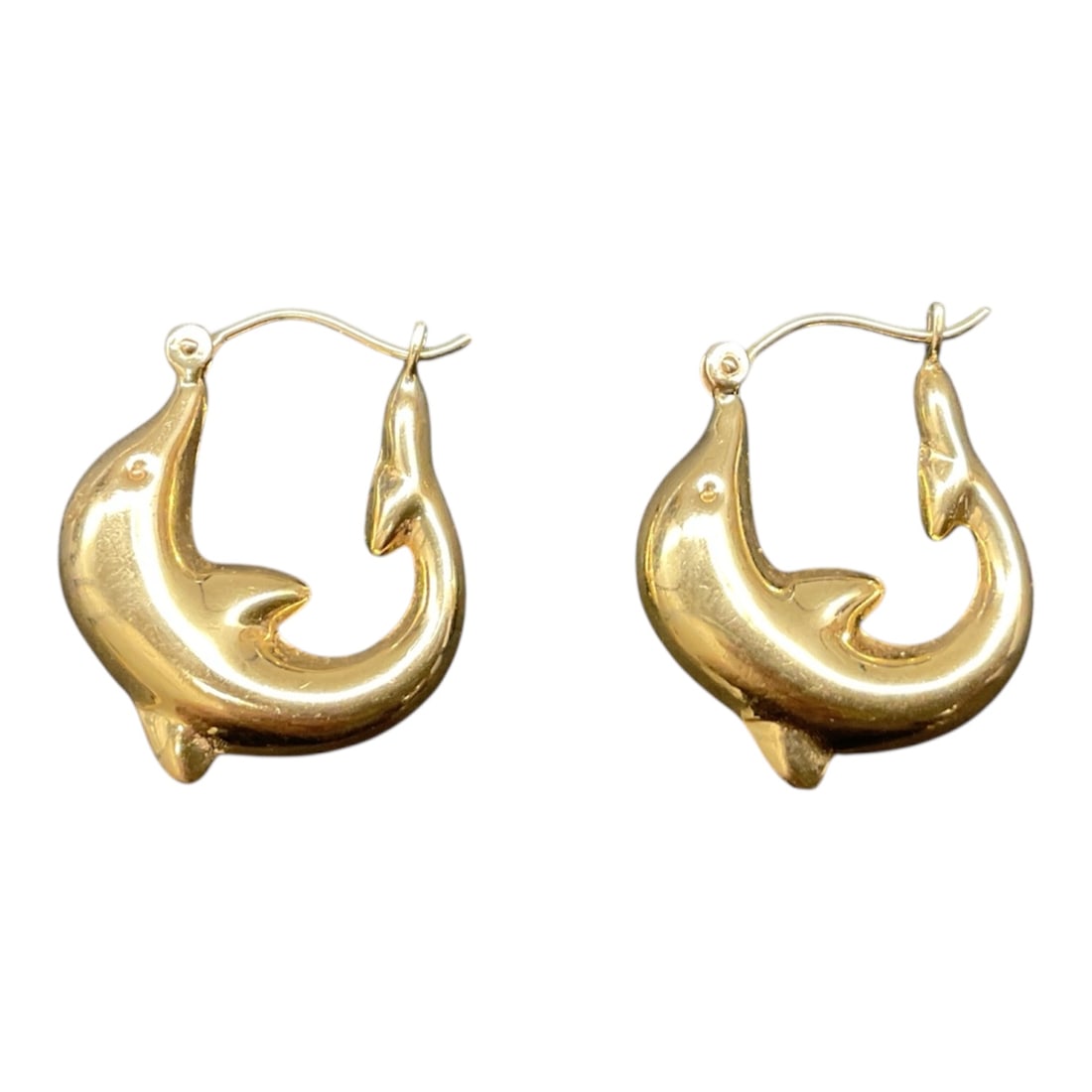 Dolphin Earrings 14k: Pair of 14K gold dolphin form hoop earrings featuring sculptural curved bodies forming the hoop silhouette. Each earring is designed as a stylized dolphin with smooth polished surfaces and integrated