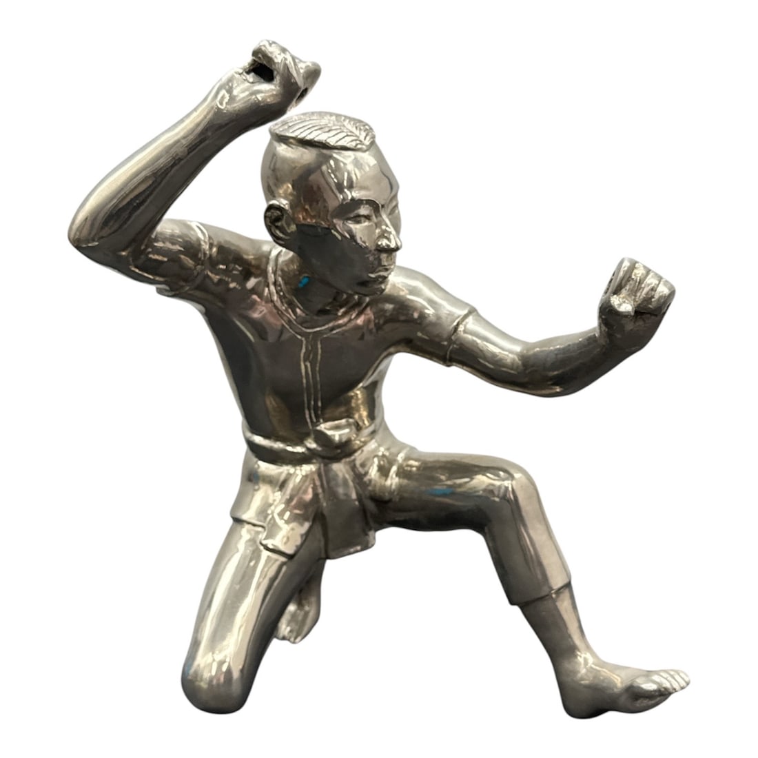 Silver Tone Figural Martial Arts Sculpture: Dynamic silver tone figural sculpture depicting a martial arts practitioner in an active fighting stance. The figure is modeled with defined musculature and expressive posture, with one arm raised