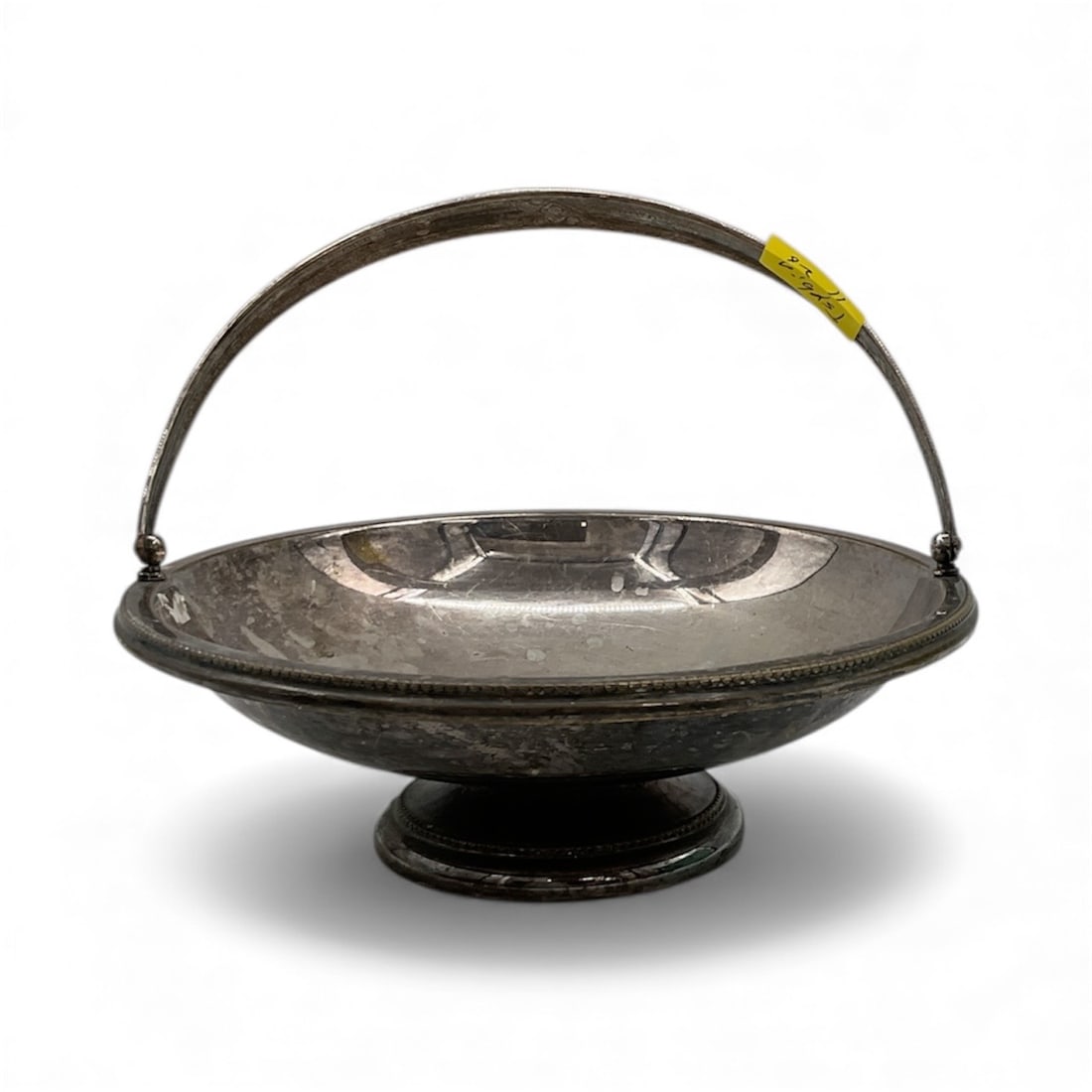 Antique Silver Plated Footed Bowl with Handle: Description: Silver plated footed bowl with handle. Features a central medallion with a classical figure.Dimensions: H:3in D:10in