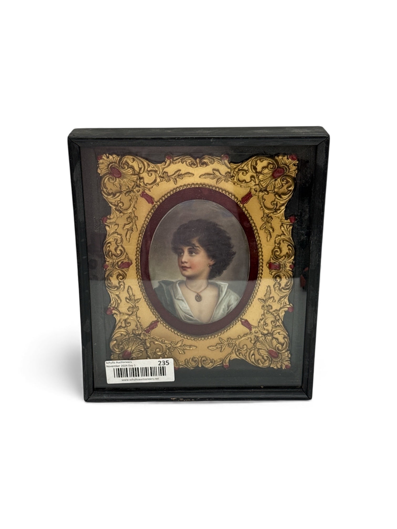 19th Century KPM German Porcelain Plaque: Description: Framed portrait miniature of a young woman with dark hair and a necklace. The frame is ornate with gold-tone details. It is often identified as being after the work