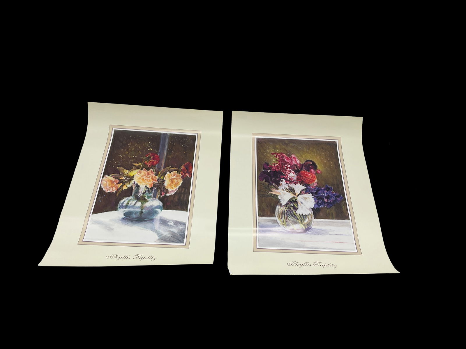 Phyllis Taplitz – Floral Still Life Poster Set (2): Pair of decorative posters by Phyllis Taplitz featuring vibrant floral arrangements in glass vases, rendered in her warm, expressive still-life style. Sold together as a matching set.Medium: Offset