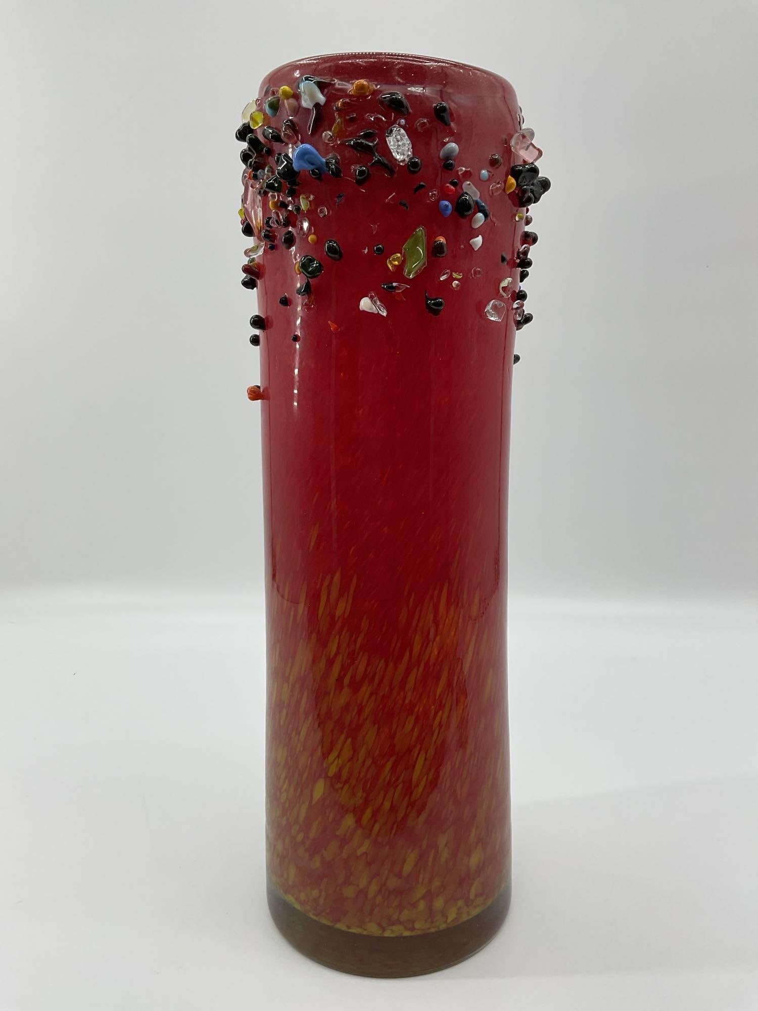 Nico Glass Romanian Art Glass Vase: Tall cylindrical art glass vase handmade in Romania by Nico Glass. Features a vivid red and yellow mottled base with multicolored applied glass accents around the rim. The surface is highly polished w