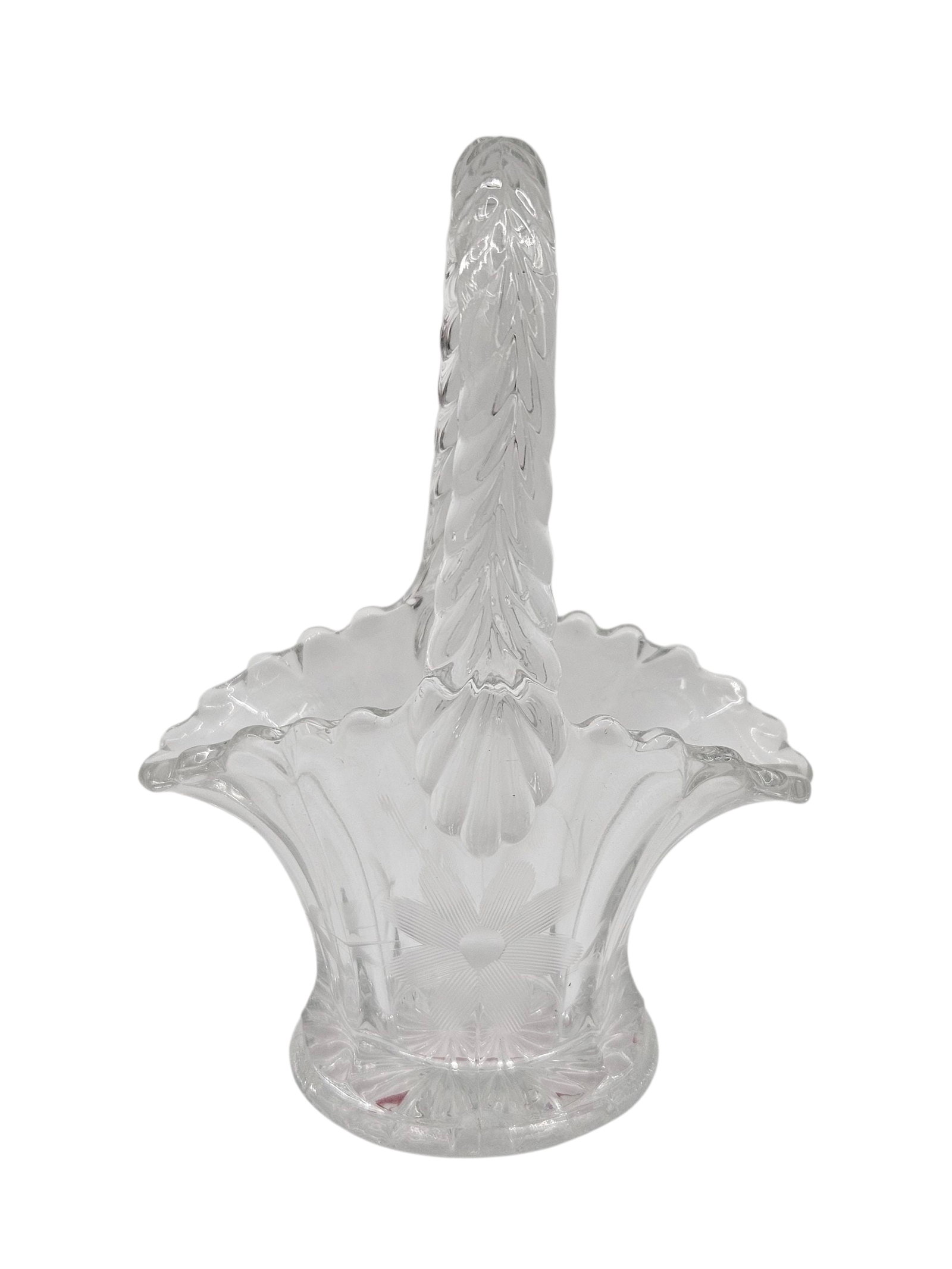 Vintage Pressed Glass Basket Vase: Clear pressed glass basket vase featuring an ornate handle with a leaf motif, scalloped rim, and starburst floral design on the body and base. Likely mid-20th century, this decorative piece was often
