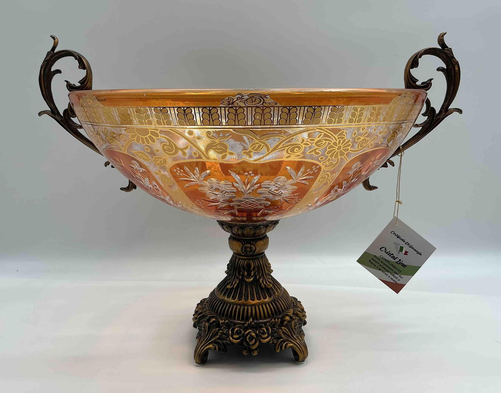 Cristal Line Italian Handcrafted Etched Glass and Metal Pedestal Bowl: Large hand-blown etched glass bowl with ornate gold and amber designs mounted on an elaborate cast metal pedestal base with scroll handles includes original Cristal Line Made in Italy tag and