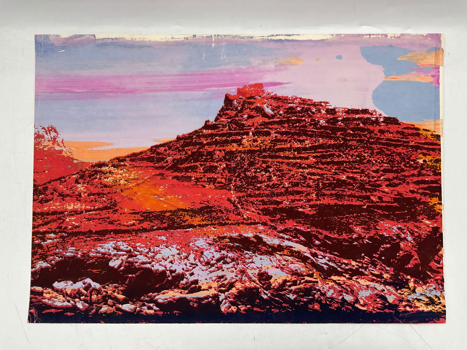 Abstract Landscape Print: Vivid abstract landscape print depicting a desert mesa in saturated tones of red, orange, and pink. The bold use of color and texture creates a dramatic and surreal interpretation of a Southwestern