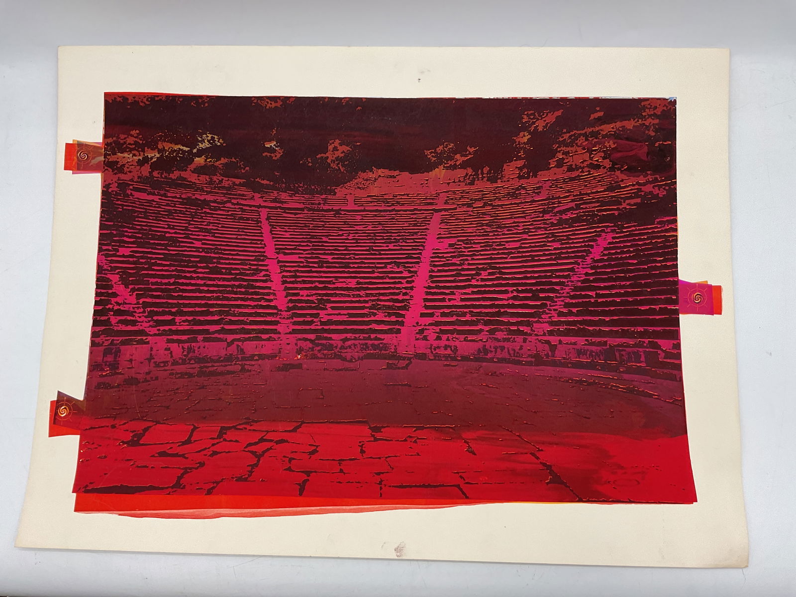 Amphitheater Abstract Print: Striking abstract photographic print depicting an ancient amphitheater in deep red and magenta tones. The image captures the geometry and texture of the stone seating with a modern, experimental