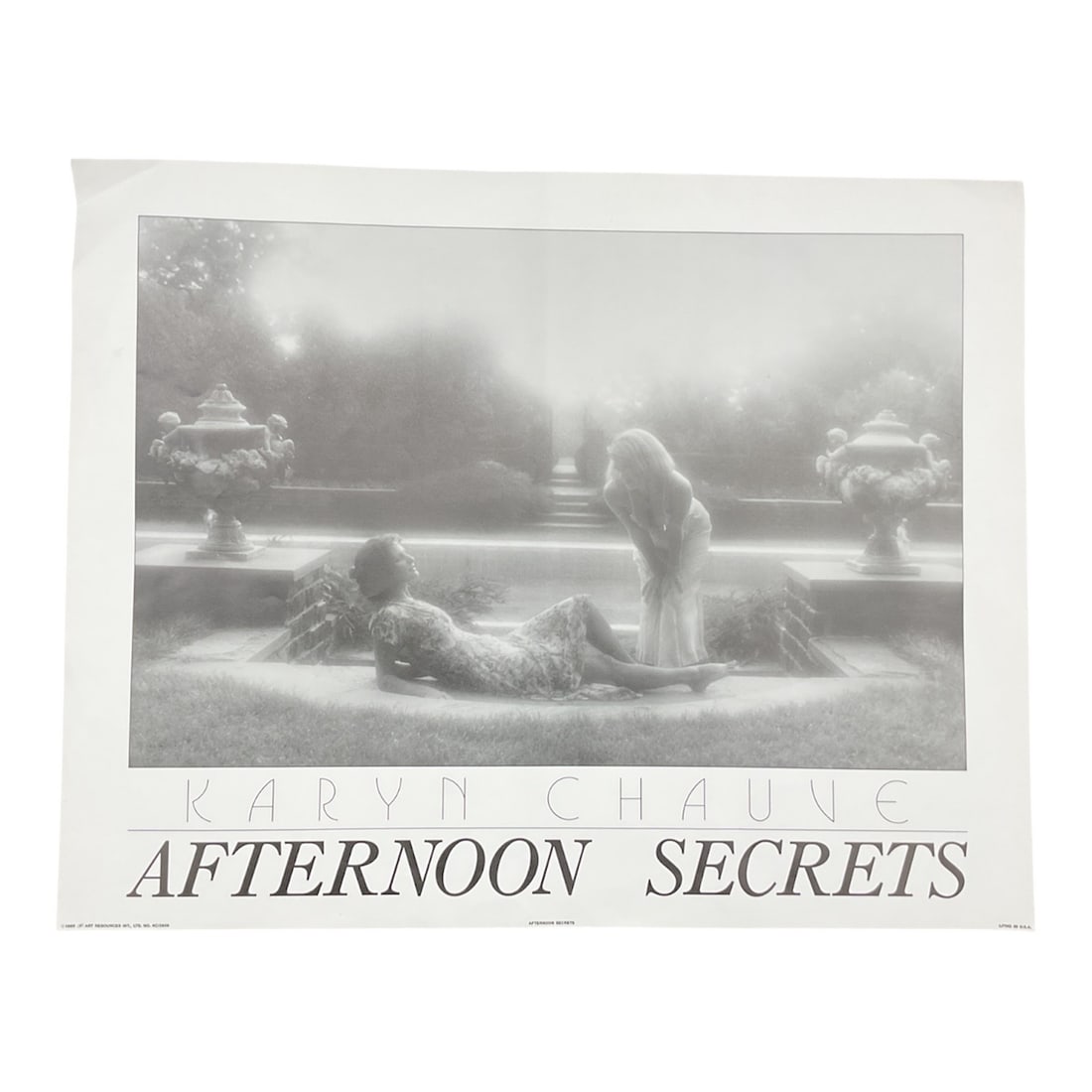 Afternoon Secrets by Karyn Chauve: This evocative photographic print titled Afternoon Secrets by Karyn Chauve presents a serene and intimate garden scene rendered in soft monochromatic tones. The composition captures a quiet moment of