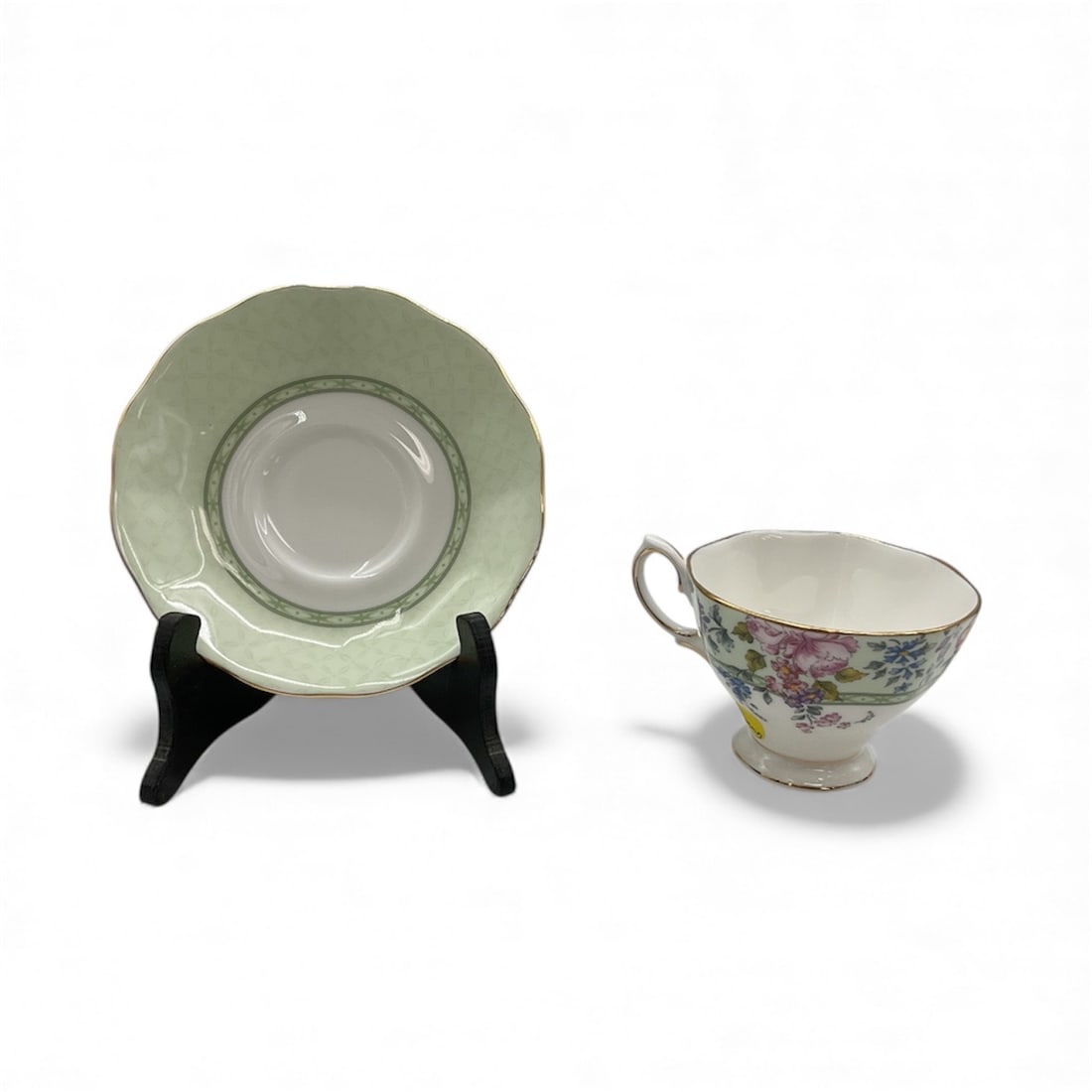 Royal Albert Floral Teacup and Saucer Set - Hartington: Elegant Royal Albert porcelain teacup and matching saucer featuring a soft green ground with delicate multicolor floral decoration and gilt rim accents. Classic English bone china craftsmanship with