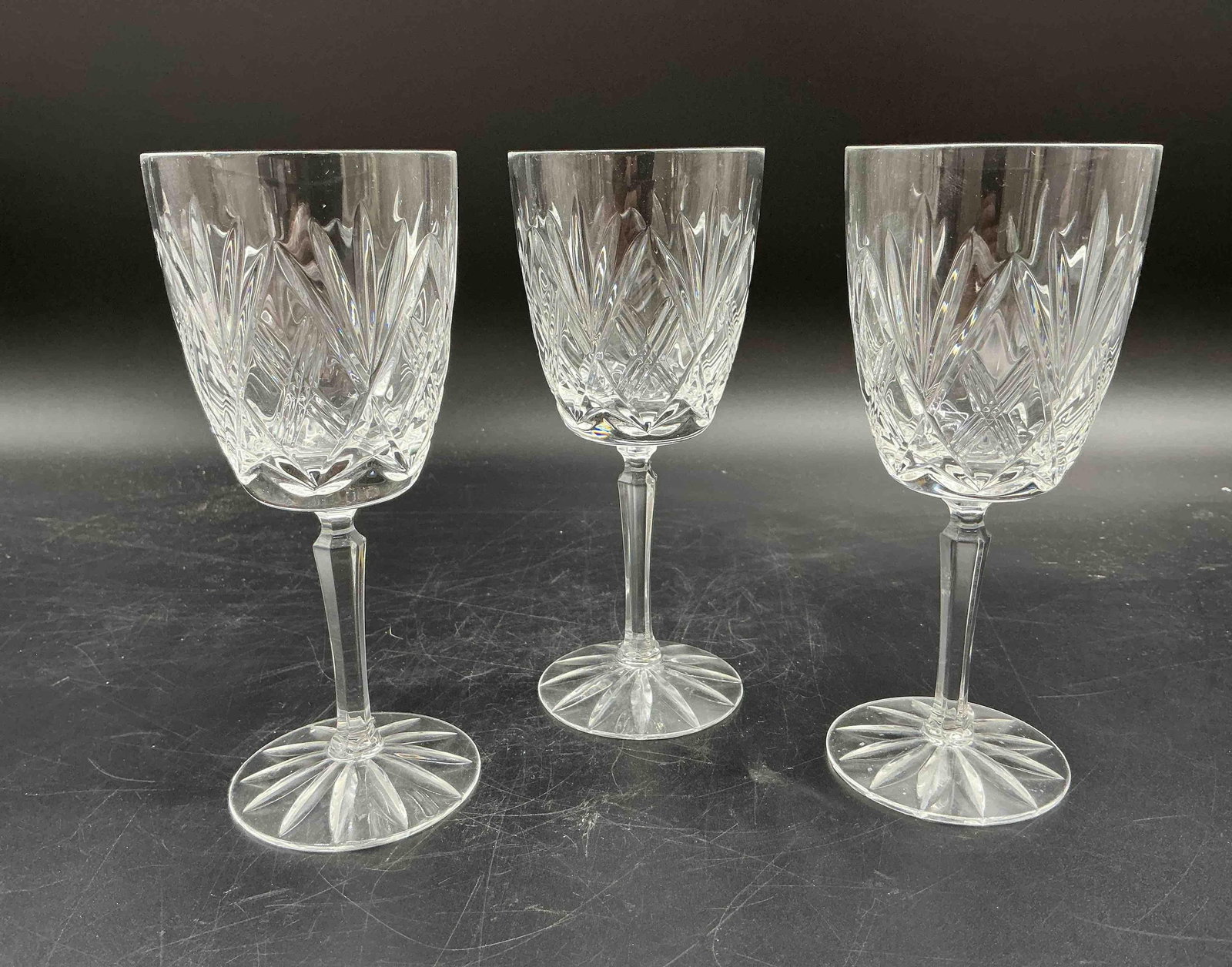 Set of 3 Vintage Cut Crystal Wine Glasses: Trio of vintage wine glasses featuring a classic cut pattern with fan and crisscross motifs. Sturdy stem and sparkling clarity. Medium: Cut crystal