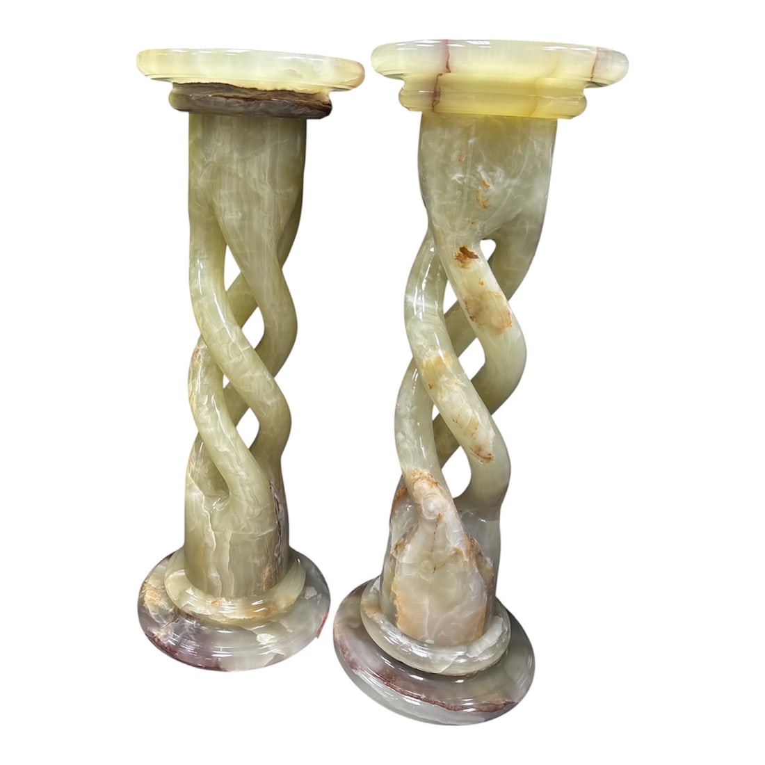 Pair of Monumental Hand-Carved Spiral Onyx Pedestals: Elevate your interior with this striking pair of monumental onyx pedestals, masterfully carved to showcase the natural translucency and intricate veining of the s