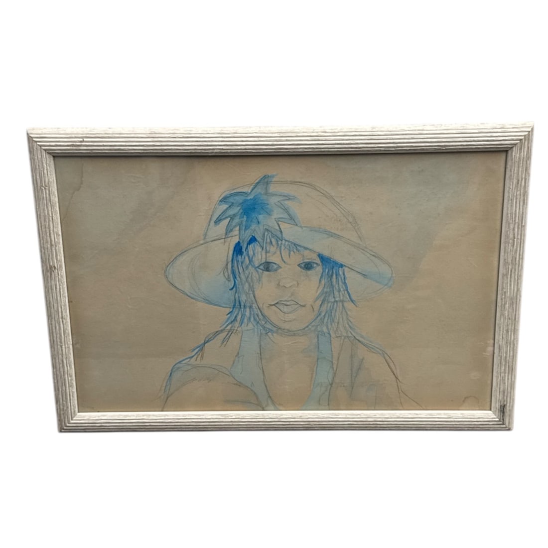 Framed Blue Line Portrait Drawing of Woman in Hat: This framed drawing depicts a woman wearing a wide-brimmed hat, rendered in expressive blue line work against a softly toned background. The loose, gestural lines emphasize facial expression and
