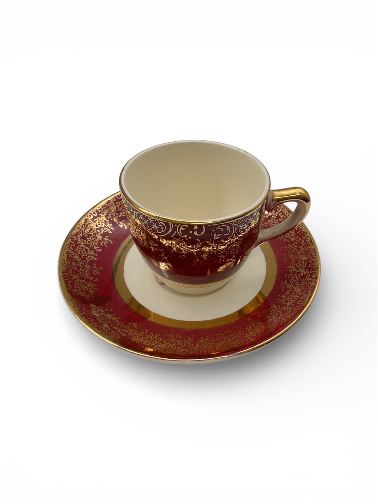 Aristocrat by Salem China Demitasse Cup and Saucer Set with Gold Decoration: This refined demitasse cup and saucer set is from the Aristocrat pattern by Salem China Company, made in the United States. The set features a deep ruby red ground richly embellished with ornate gold