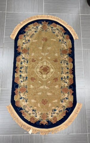 Antique Peking Wool Rug, Late 19th Century: Antique Peking rug, late 19th century. Wool. The rug features a central medallion design with floral and geometric motifs in shades of beige, brown, and blue on a dark blue ground. New fringe.Dimensio