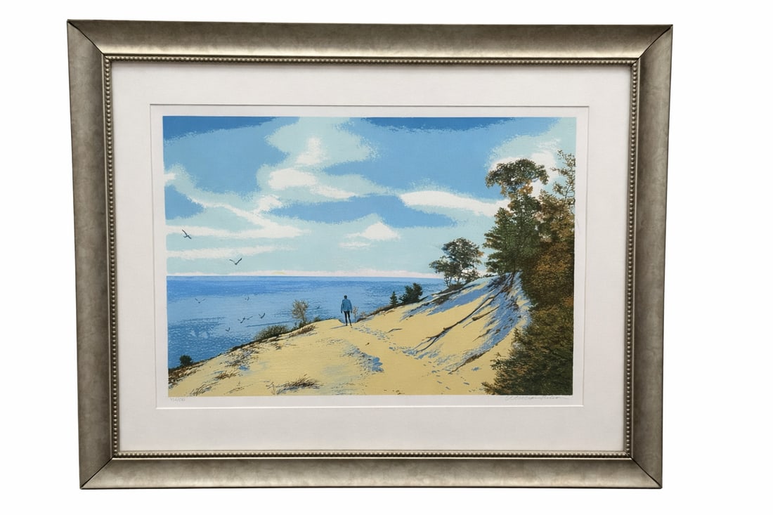 William Nelson The Dunes Limited Edition Serigraph Framed 436/500: Limited edition serigraph titled The Dunes by artist William Nelson. This serene coastal landscape depicts sunlit sand dunes overlooking a calm blue shoreline beneath a bright sky with drifting clouds