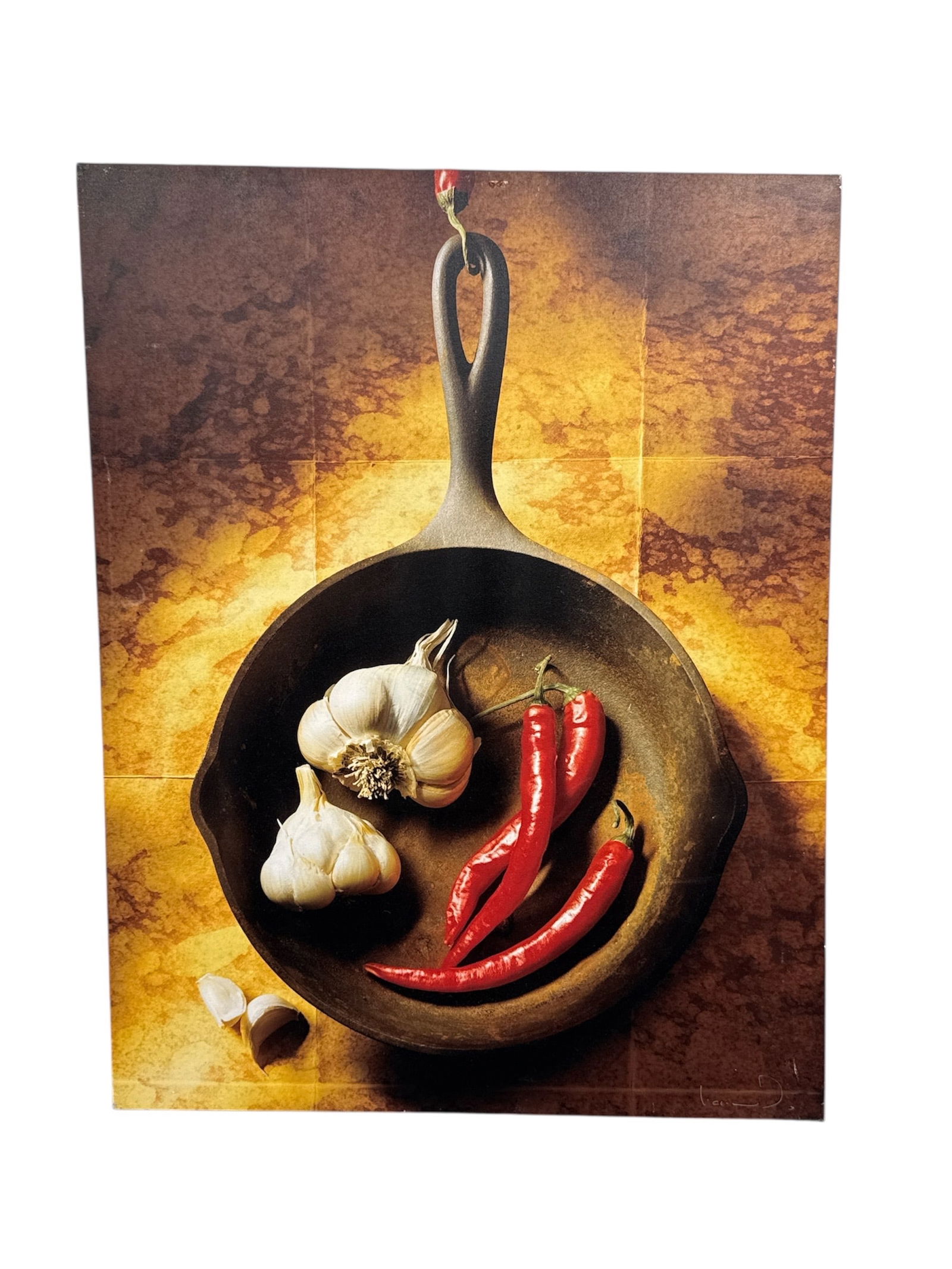 Large Signed Contemporary Food Still Life Photograph – Cast Iron Skillet with Garlic & Chili: Striking large-format contemporary photographic artwork depicting a cast iron skillet holding garlic bulbs and red chili peppers against a warm, textured background. The composition emphasizes rustic