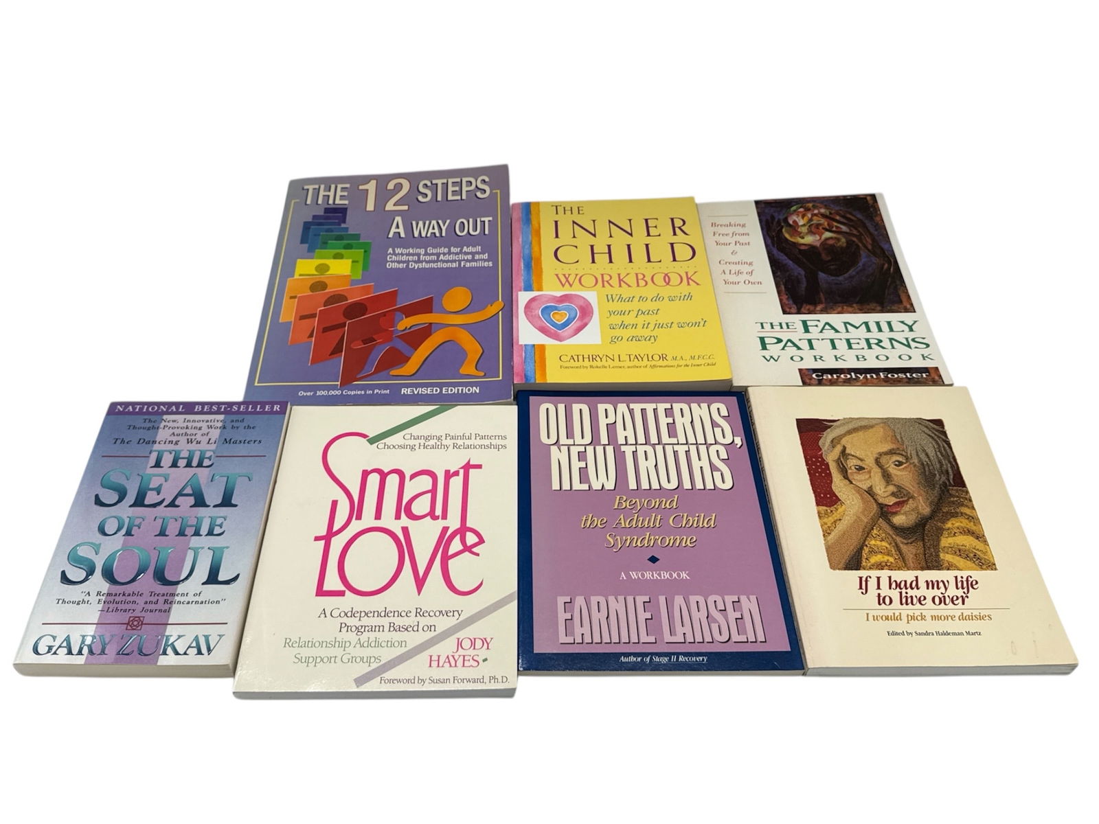 Collection of Self Help and Personal Growth Books: Assorted collection of self help and personal development books addressing topics such as emotional healing, inner child work, relationships, spirituality, and recovery. The group includes well-known