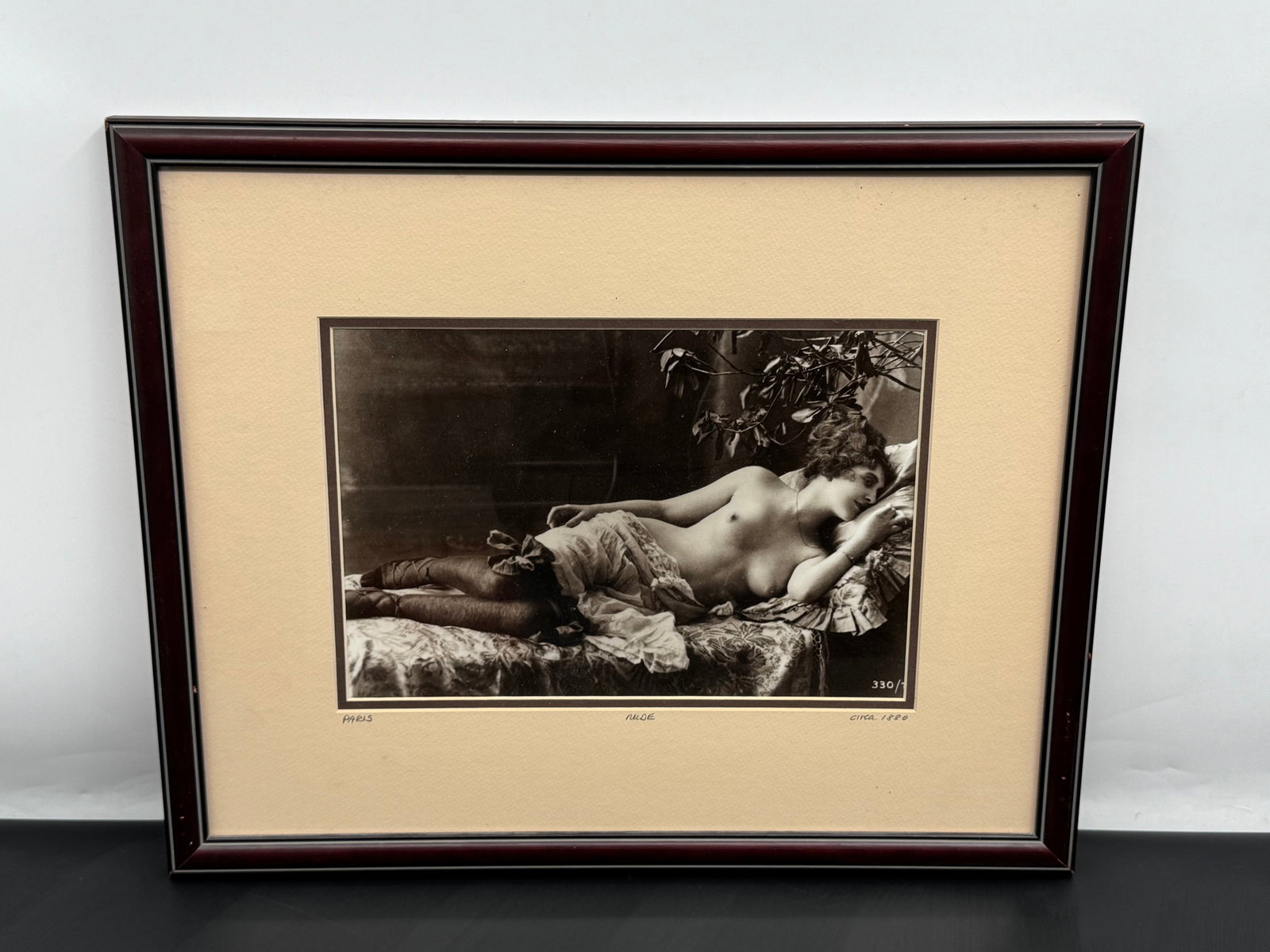 Vintage Parisian Nude Photogravure, Circa 1880: Elegant vintage photogravure depicting a reclining nude woman in a softly lit interior, attributed to Paris and dating circa 1880. The sepia-toned image showcases classic 19th-century photographic