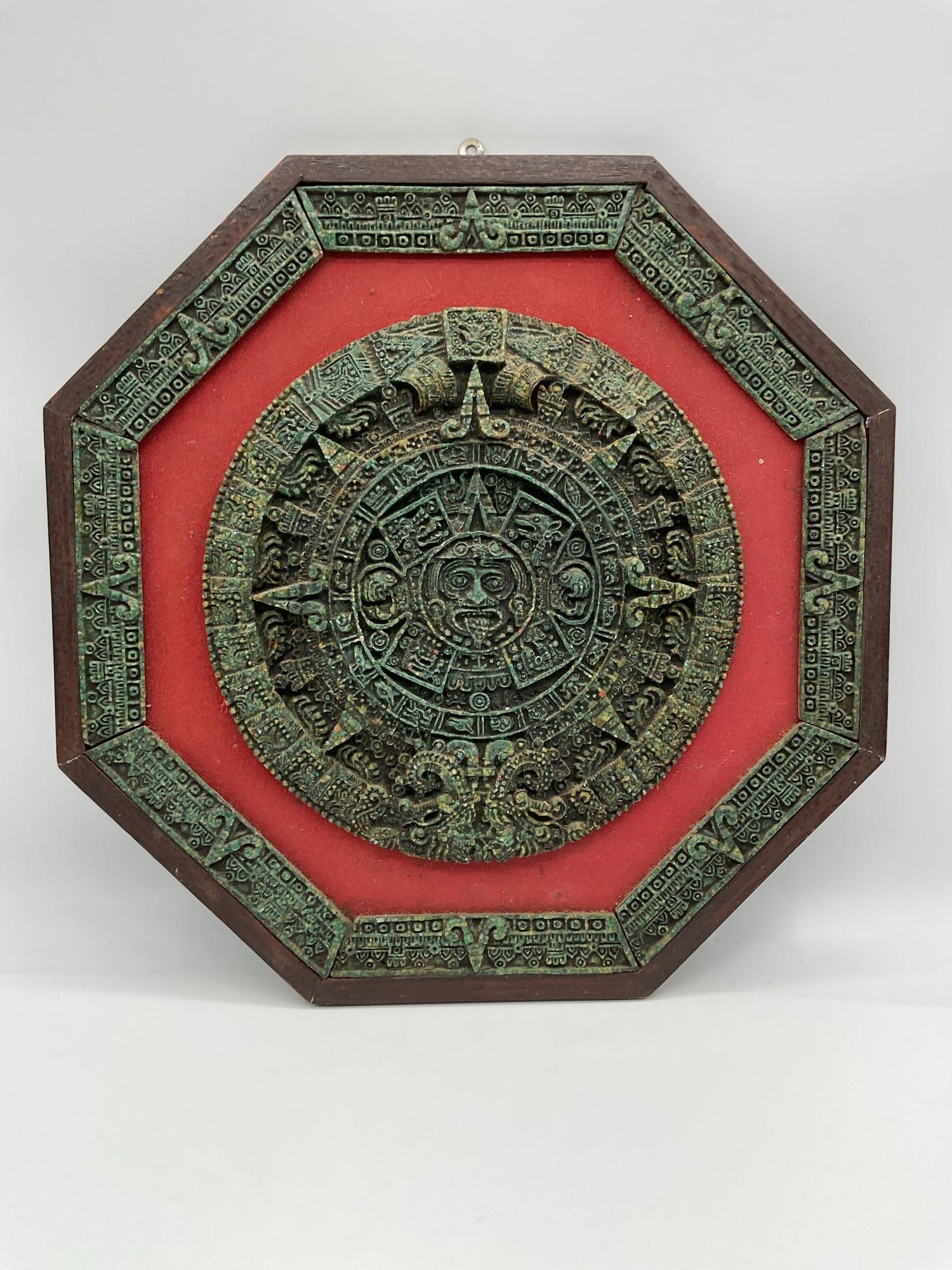Decorative Aztec Calendar Wall Plaque: A detailed relief reproduction of the Aztec Sun Stone, also known as the Calendar Stone, mounted in a red velvet-lined octagonal wood frame. Features traditional Aztec symbols and deities surrounding