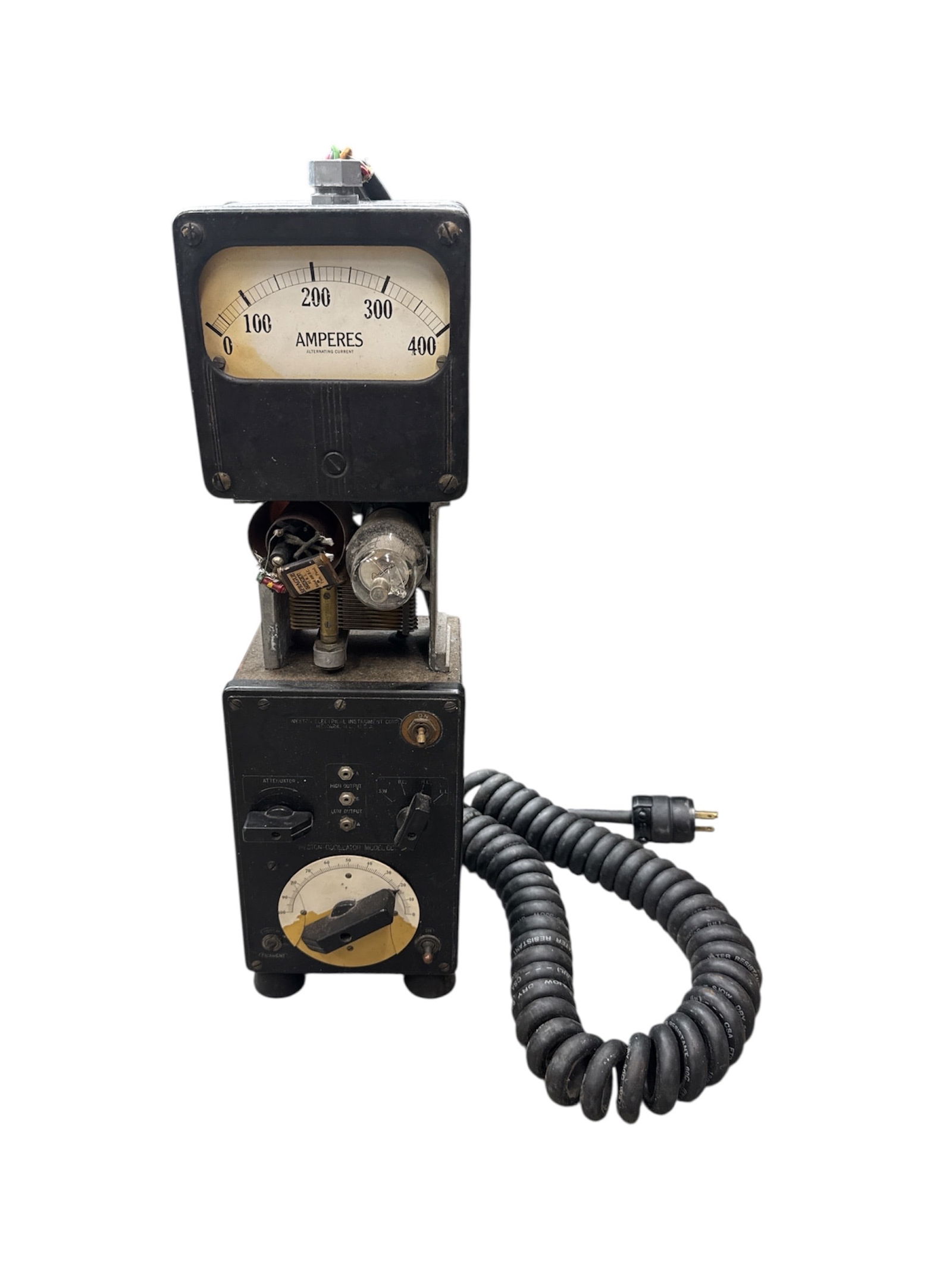 Vintage Industrial Ampere Meter Electrical Testing Unit: Vintage industrial electrical testing unit featuring an analog ampere meter mounted above a control housing with dials, switches, and exposed components. The unit includes a heavy-duty coiled power