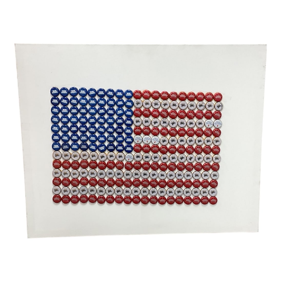 American Flag Bottle Cap Composition: Mixed media composition on paper depicting the American flag constructed from repeating circular bottle cap motifs in red, white, and blue. The work presents a graphic, pop-art–inspired interpre
