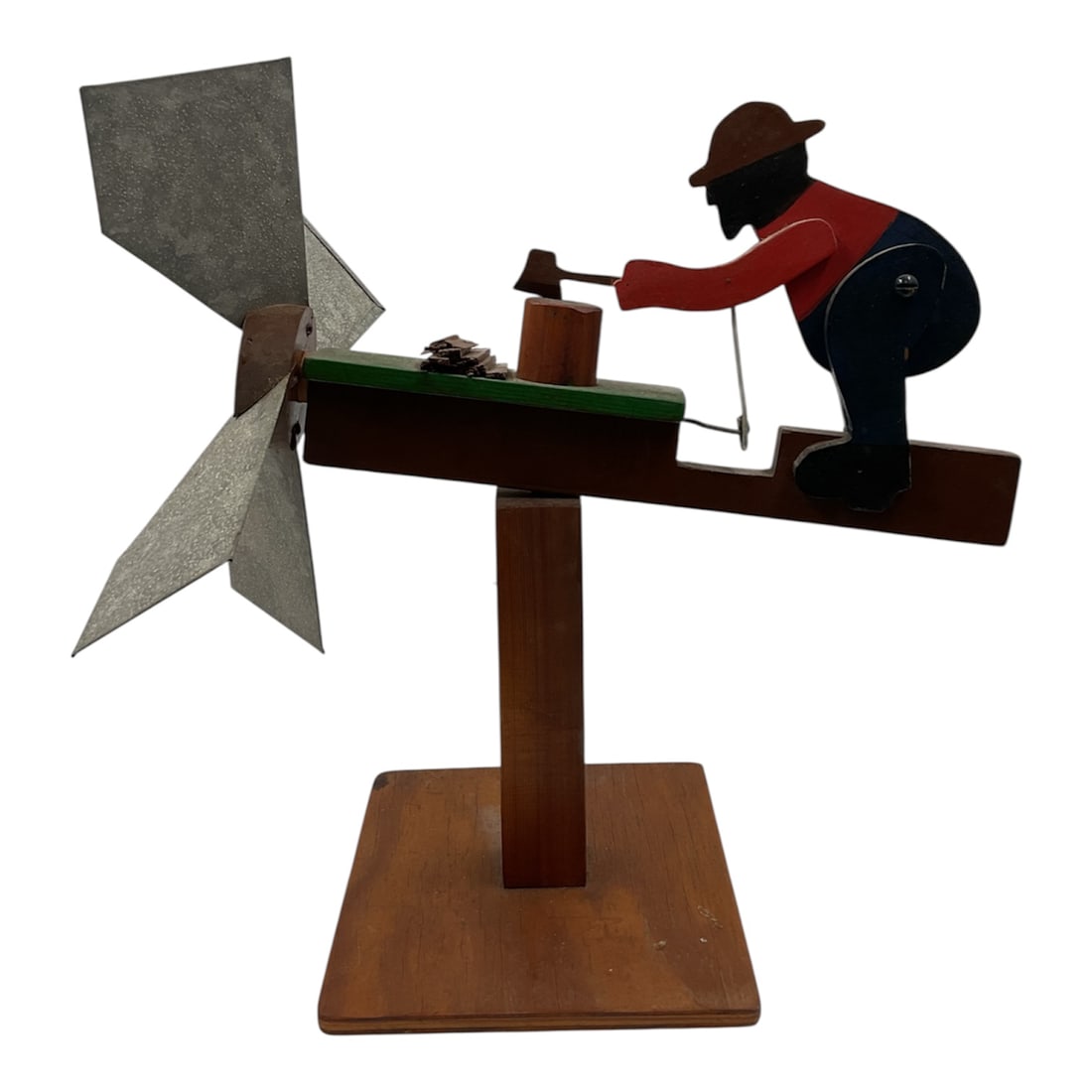 Vintage American Folk Art Whirligig Depicting Man Chopping Wood: Charming vintage American folk art whirligig featuring a hand crafted figure of a man actively chopping wood. The painted wooden figure is mounted on a horizontal beam with a metal wind driven propell