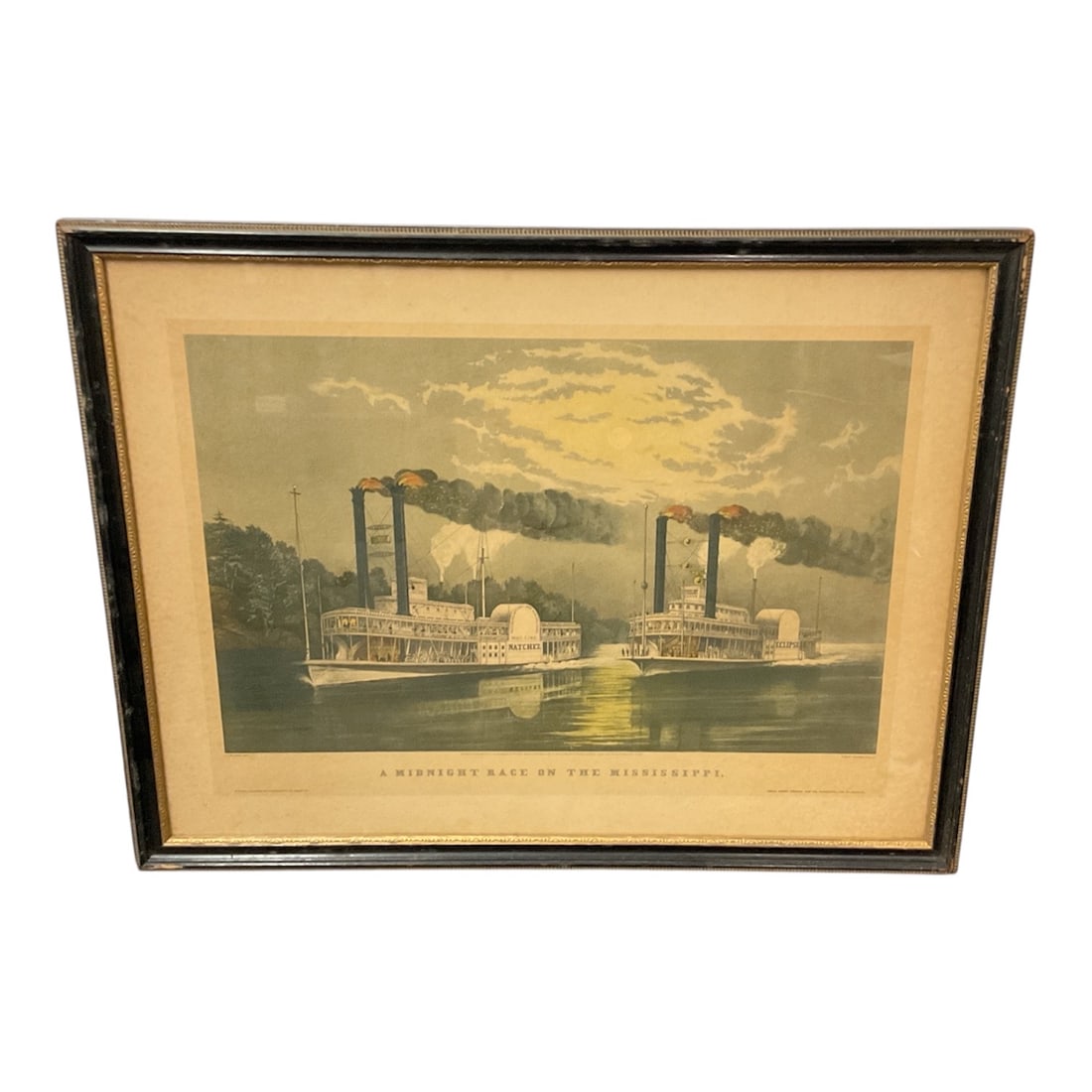 A Midnight Race on the Mississippi Framed Currier and Ives Style Print: Framed print titled A Midnight Race on the Mississippi depicting two paddlewheel steamboats racing along the river under a dramatic moonlit sky. The colorful scene captures the excitement of 19th
