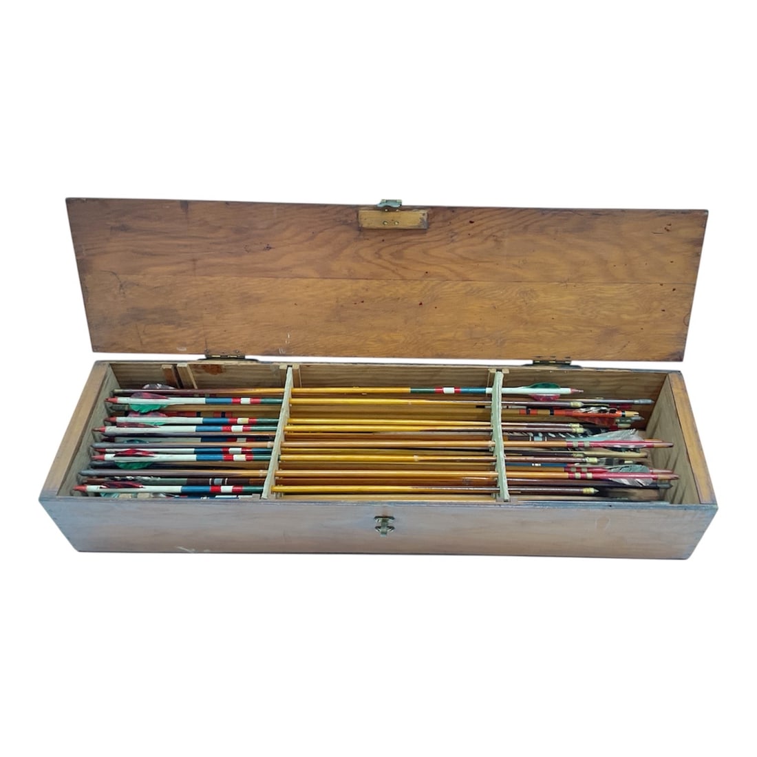 Vintage Archery Arrow Collection in Wooden Storage Case with IndX Nocks Sheet: Large collection of vintage archery arrows housed in a fitted wooden storage case. The rectangular hinged case opens to reveal organized rows of arrows featuring multicolor fletching and wooden shafts