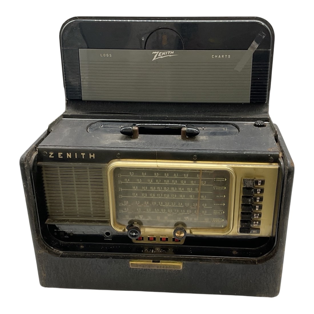 Zenith Trans Oceanic Portable Shortwave Radio: Vintage Zenith Trans Oceanic portable shortwave radio housed in a black case with integrated handle and hinged top compartment. The front panel features a large multi band tuning dial with world band