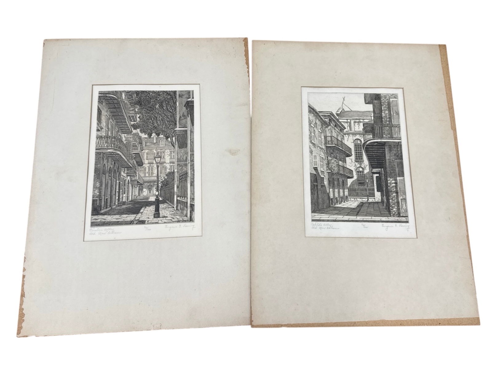 Pair of Eugene E. Loving Etchings Pirate's Alley and Orleans Alley Old New Orleans: Offered is a pair of finely detailed black and white etchings by Eugene E. Loving depicting historic New Orleans street scenes titled Pirate's Alley and Orleans Alley. Each work captures the charm