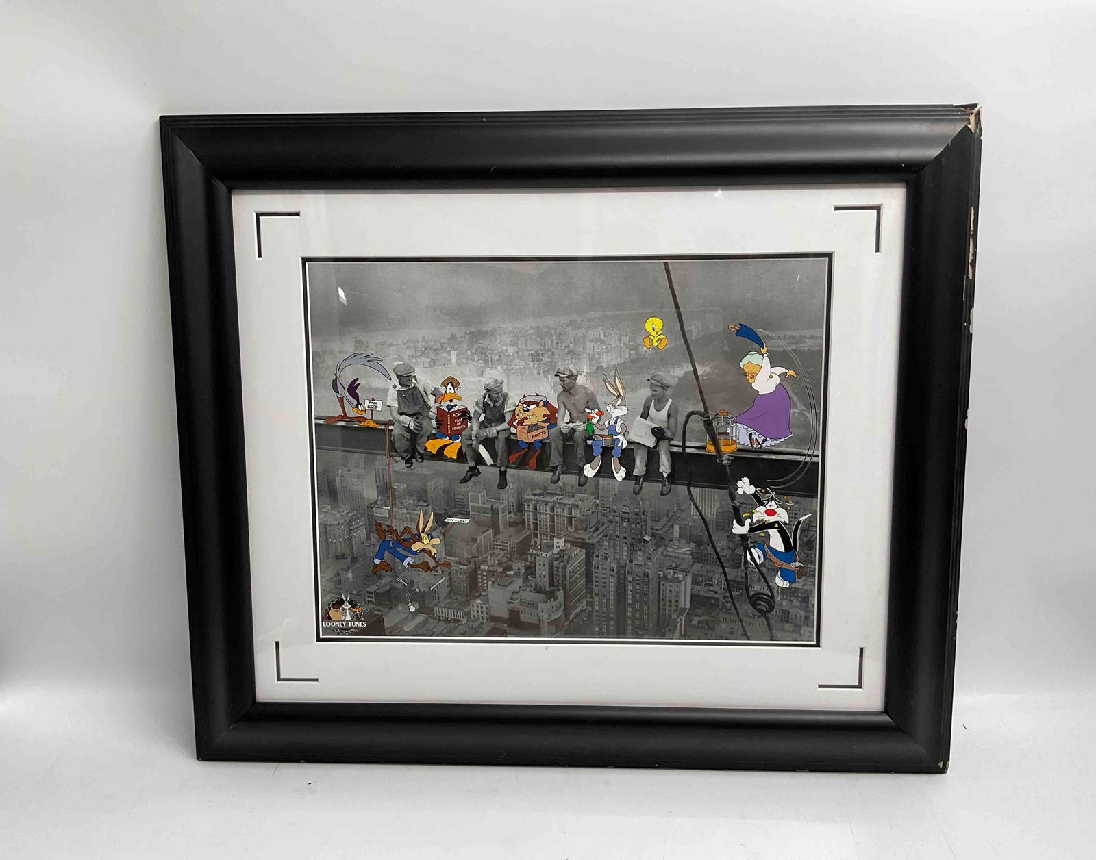 Lunch Break – Warner Bros. Studio Limited Edition Lithograph: Description: Warner Bros. color lithograph titled Lunch Break, featuring an ensemble of classic Looney Tunes characters in a playful parody of the iconic “Lunch Atop a Skyscraper”