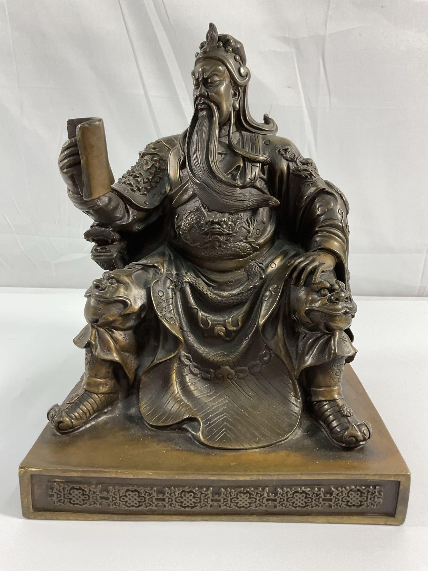 Guan Yu / Guan Gong Chinese Bronze Statue: This is a bronze or bronze-finished metal statue depicting Guan Yu, a legendary general from Chinese history and folklore, known for his loyalty, bravery, and righteousness. Guan Yu is often