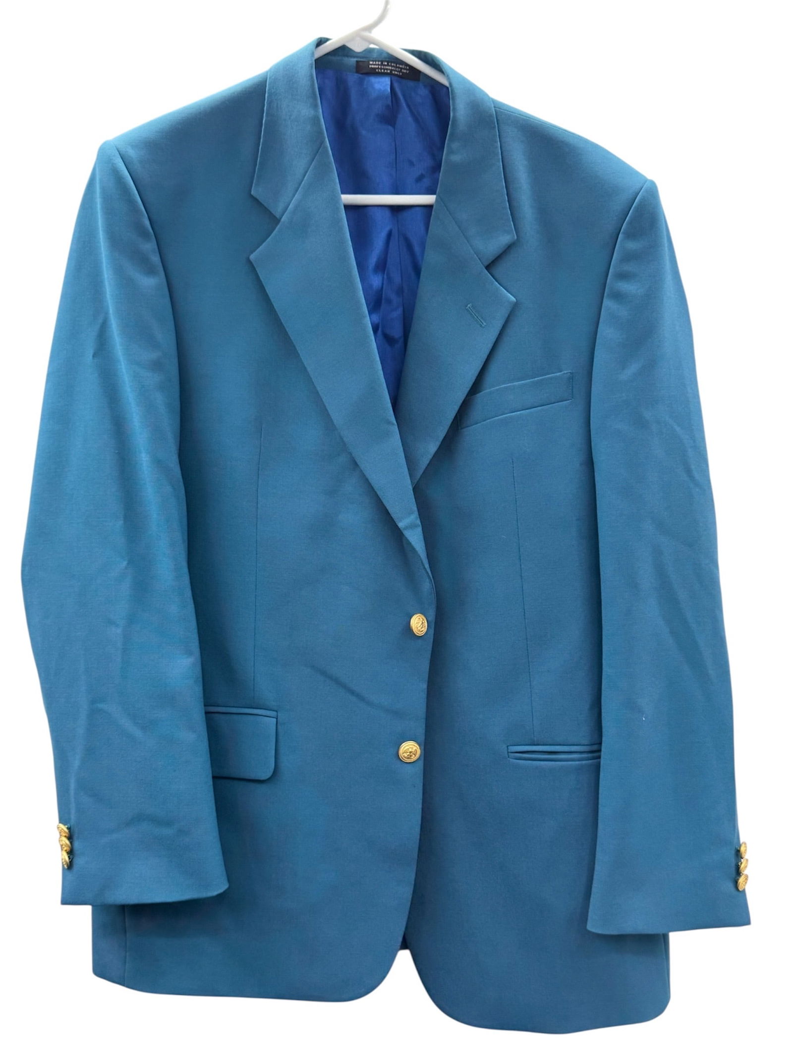 Stefano Classic Collection Blue Blazer Size 42R: A tailored men’s blazer from the Stefano Classic Collection featuring a rich blue fabric and a classic structured silhouette. The jacket is designed with a two-button front closure accented by g