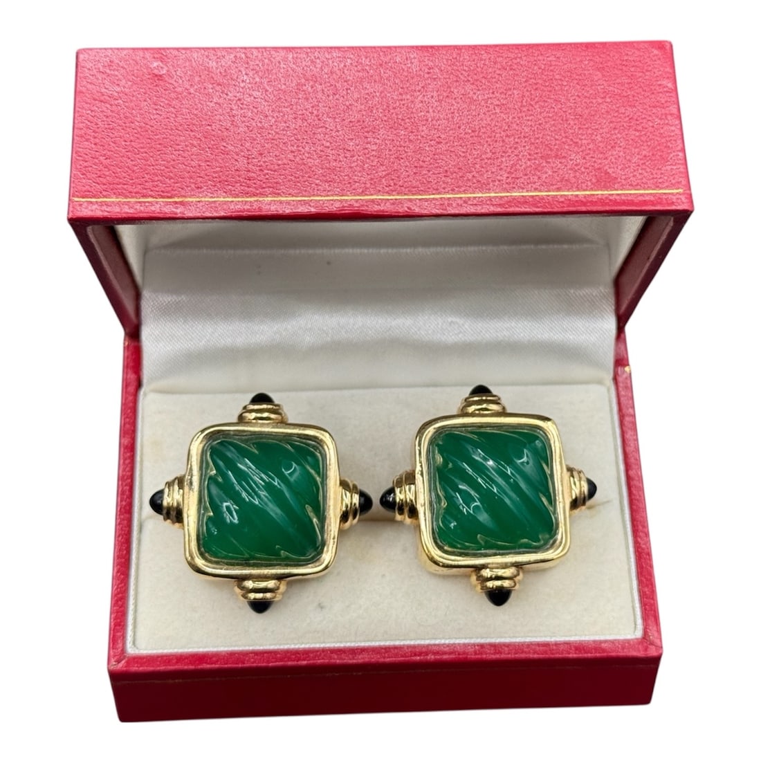 Pair of Gold Tone Cufflinks with Green Stone Centers in Presentation Box: A sophisticated pair of gold tone cufflinks featuring square green stone centers set within decorative frames. Each cufflink displays a polished green stone with subtle natural patterning, surrounded