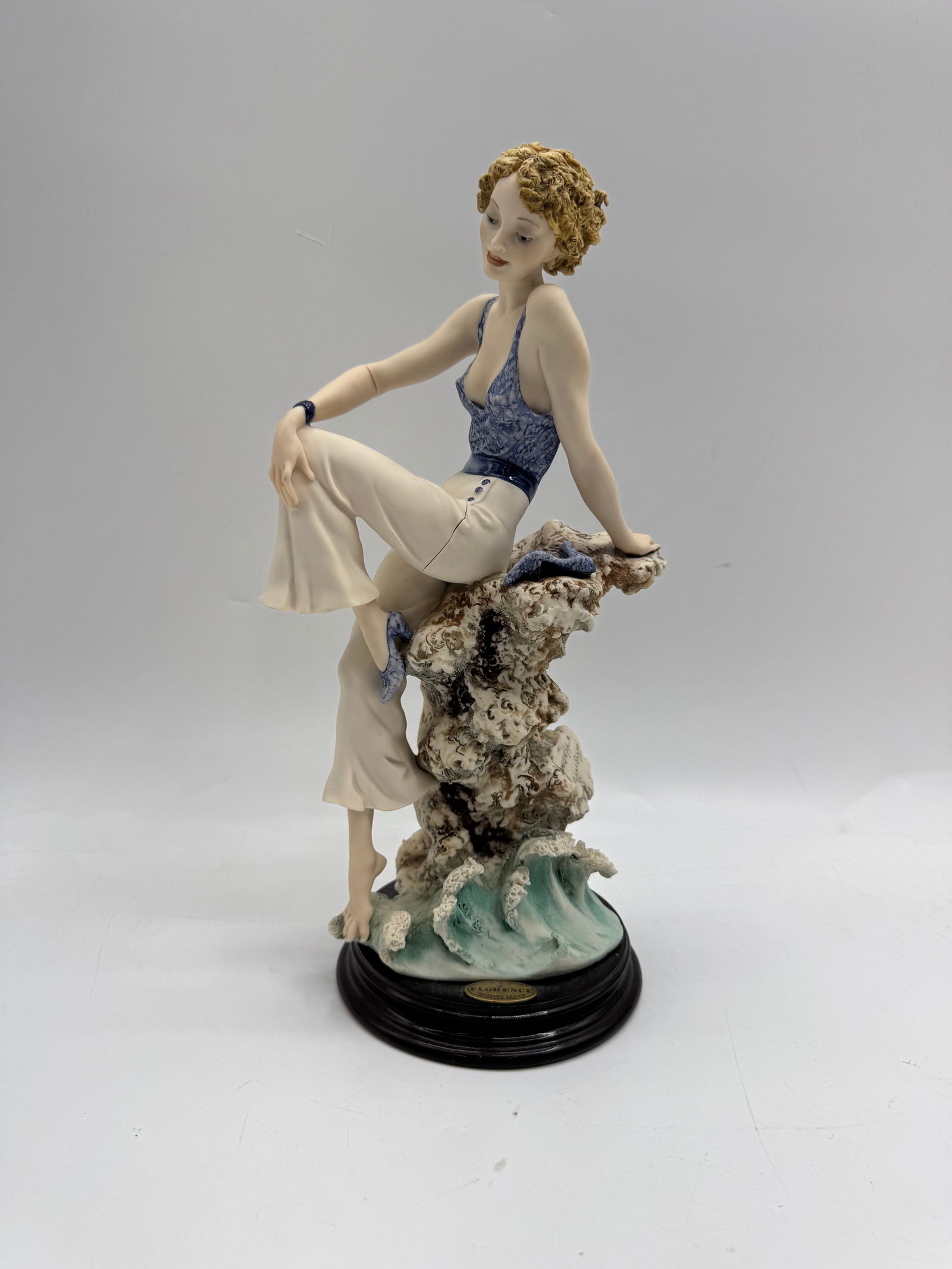 Giuseppe Armani Sabrina Figurine: Description: Giuseppe Armani Florence figurine depicting a woman pulling a net. Marked on base. Dimensions: Measures approximately 12 x 5 inches.