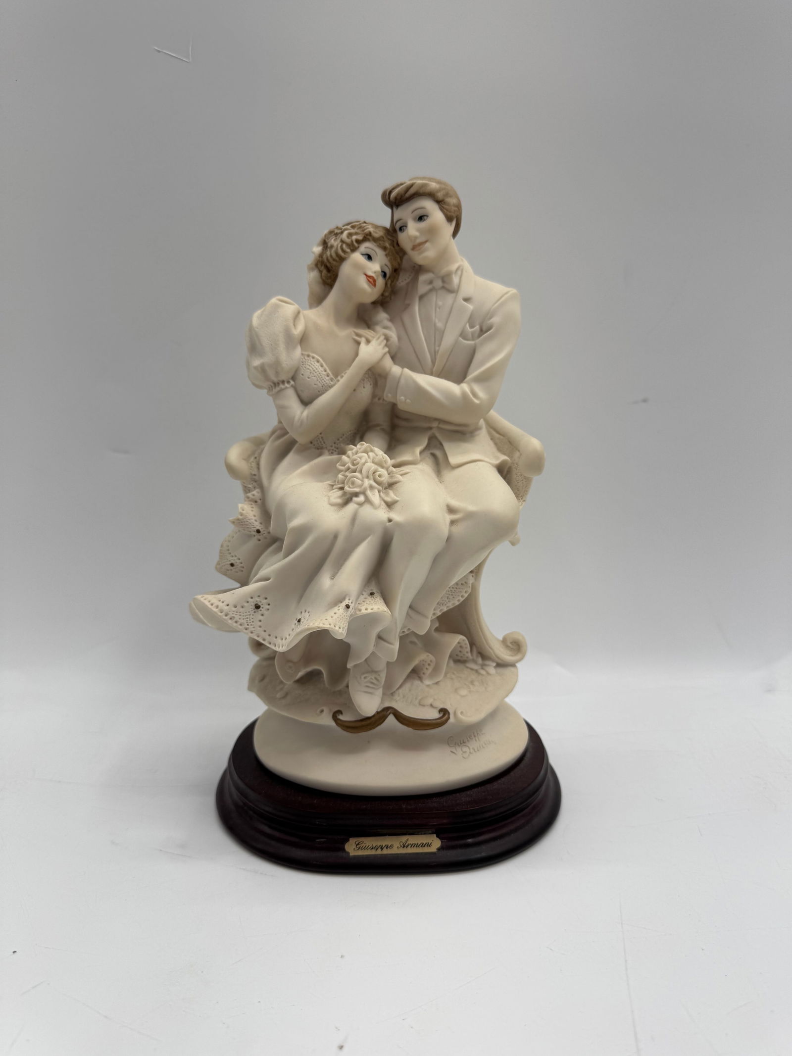 Florence Giuseppe Armani Bride & Groom Figurine: Florence Giuseppe Armani figurine depicting a bride and groom. Marked on the base. Approximate dimensions: 10 x 5 inches.