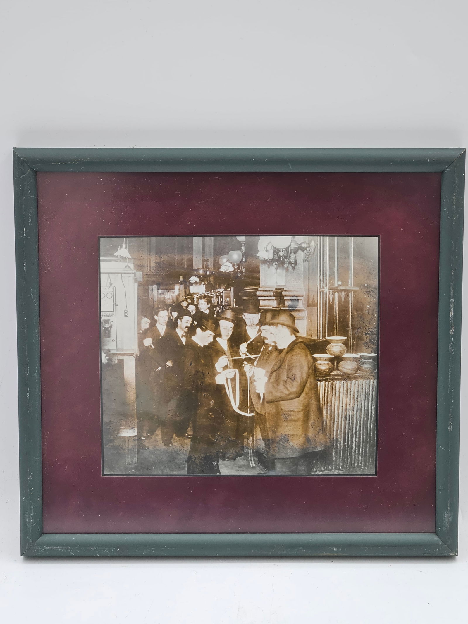 Vintage Department Store Photograph: Early 20th-century black and white photograph capturing a moment inside a department store, featuring elegantly dressed figures and elaborate displays of ceramics and glassware. The image offers a gli