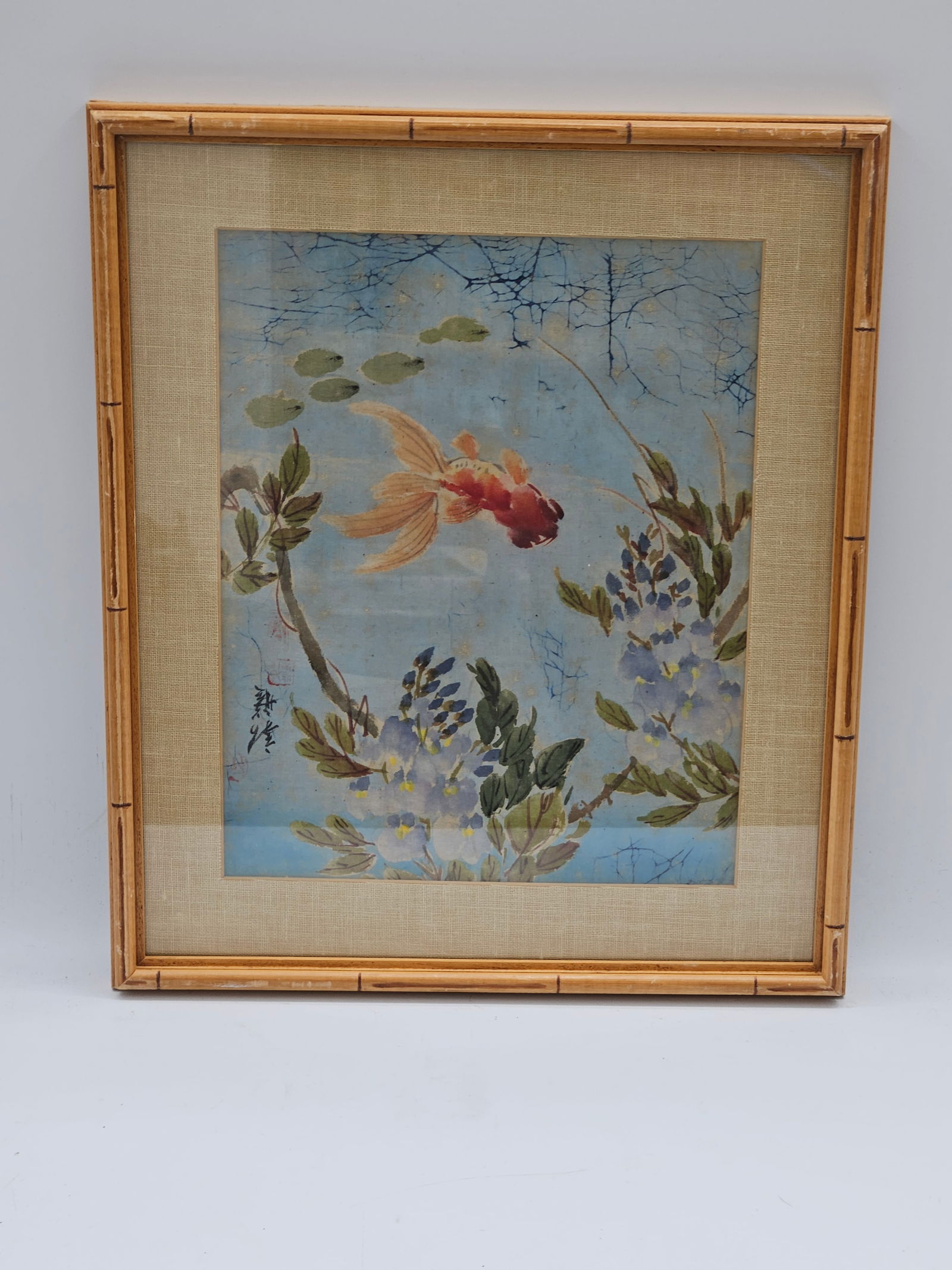 Goldfish and Lilies: A serene print featuring a vibrant goldfish swimming among water lilies, surrounded by soft blue water and subtle reflections. The artwork captures an elegant, tranquil moment inspired by