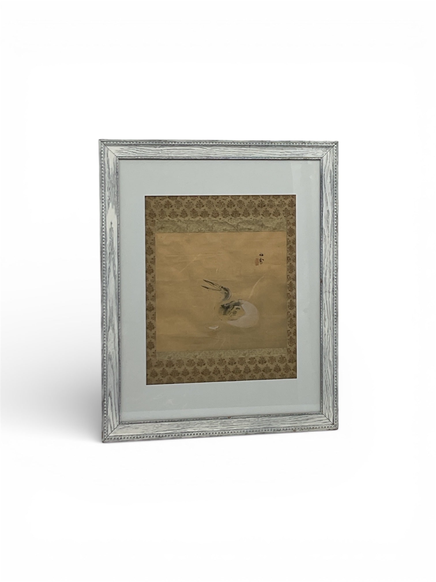 Japanese Ink & Wash Painting of Bird (Possibly Crane or Waterfowl): Traditional East Asian ink and wash painting depicting a bird resting near water, rendered with expressive brushwork and restrained palette. The composition is mounted on silk with decorative brocade-