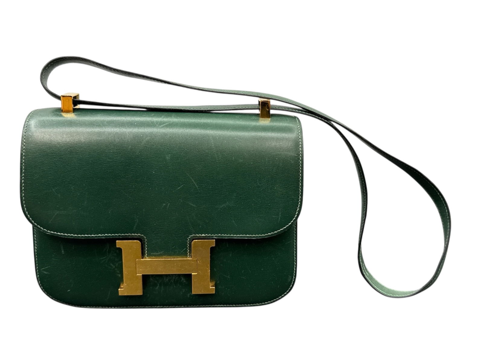 Hermès Paris Constance Shoulder Bag – Green Box Calf Leather (7x9x2in): Elegant Hermès Constance shoulder bag crafted in rich green box calf leather featuring the iconic gold-tone “H” clasp closure. Interior stamped “Herm&e