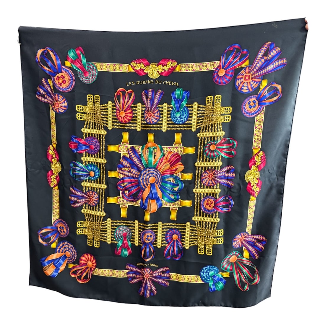 Hermes Paris Les Rubans du Cheval Silk Scarf 34x34in: Elegant Hermes Paris silk scarf titled Les Rubans du Cheval, featuring an intricate equestrian-inspired design of ornate ribbons, rosettes, and decorative tack arranged within a gold frame border agai