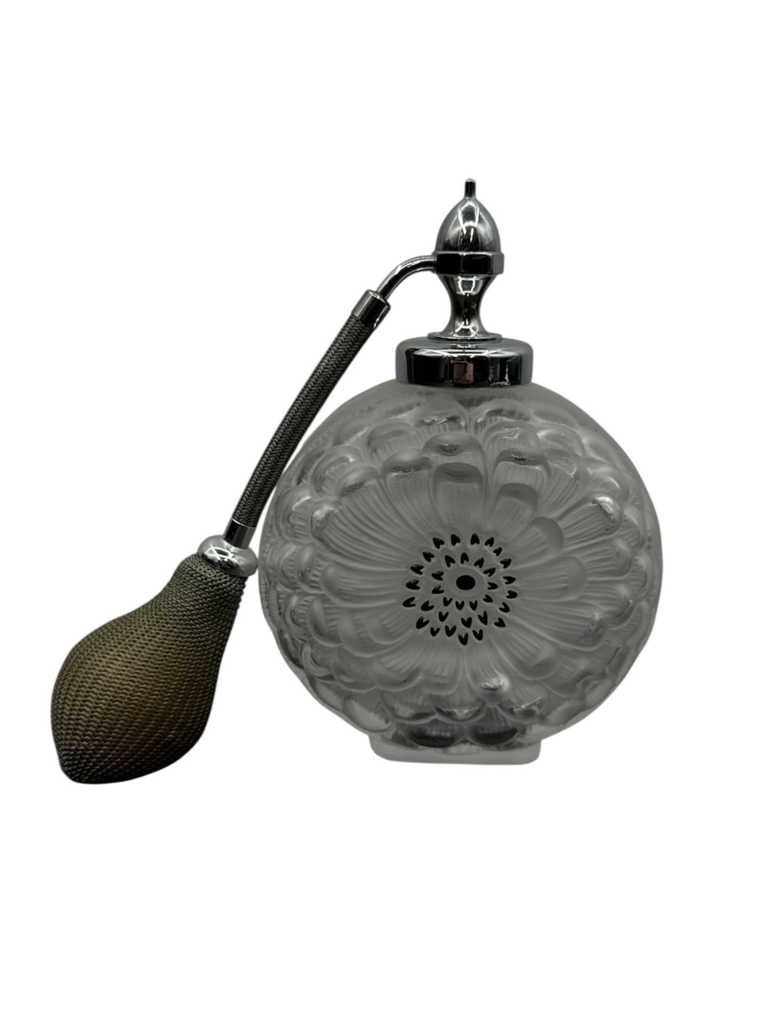 Lalique Dahlia Frosted Crystal Perfume Bottle with Atomizer: Exquisite Lalique Dahlia perfume bottle crafted in frosted crystal, featuring the iconic molded dahlia blossom motif radiating across the circular body. The bottle is fitted with a silver tone mount a