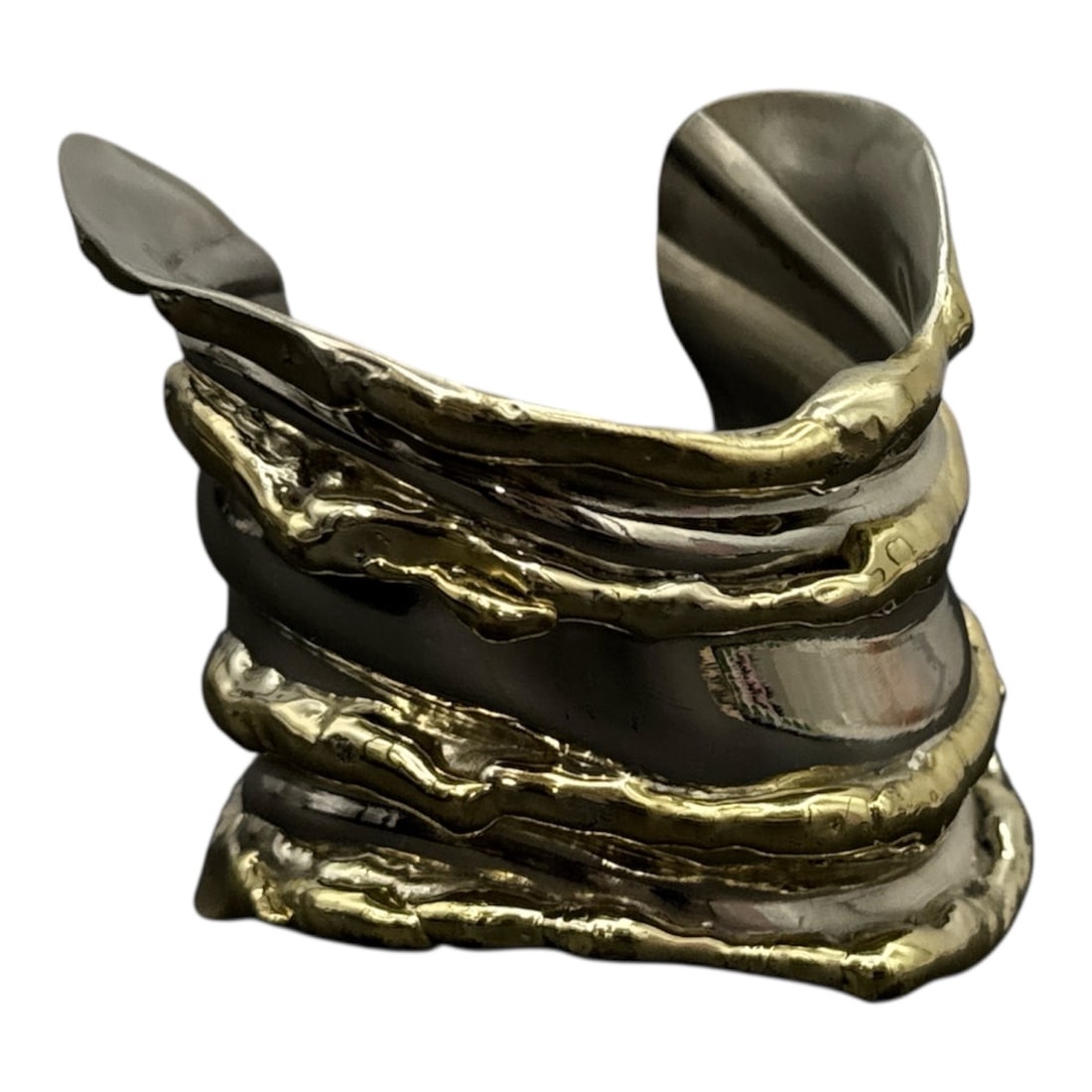 Allen Jacobsen Sculptural Metal Cuff Bracelet: Bold sculptural cuff bracelet by Allen Jacobsen, featuring an organic, flowing form with contrasting finishes. The design incorporates layered, textured elements in warm gilt tones against a brushed s